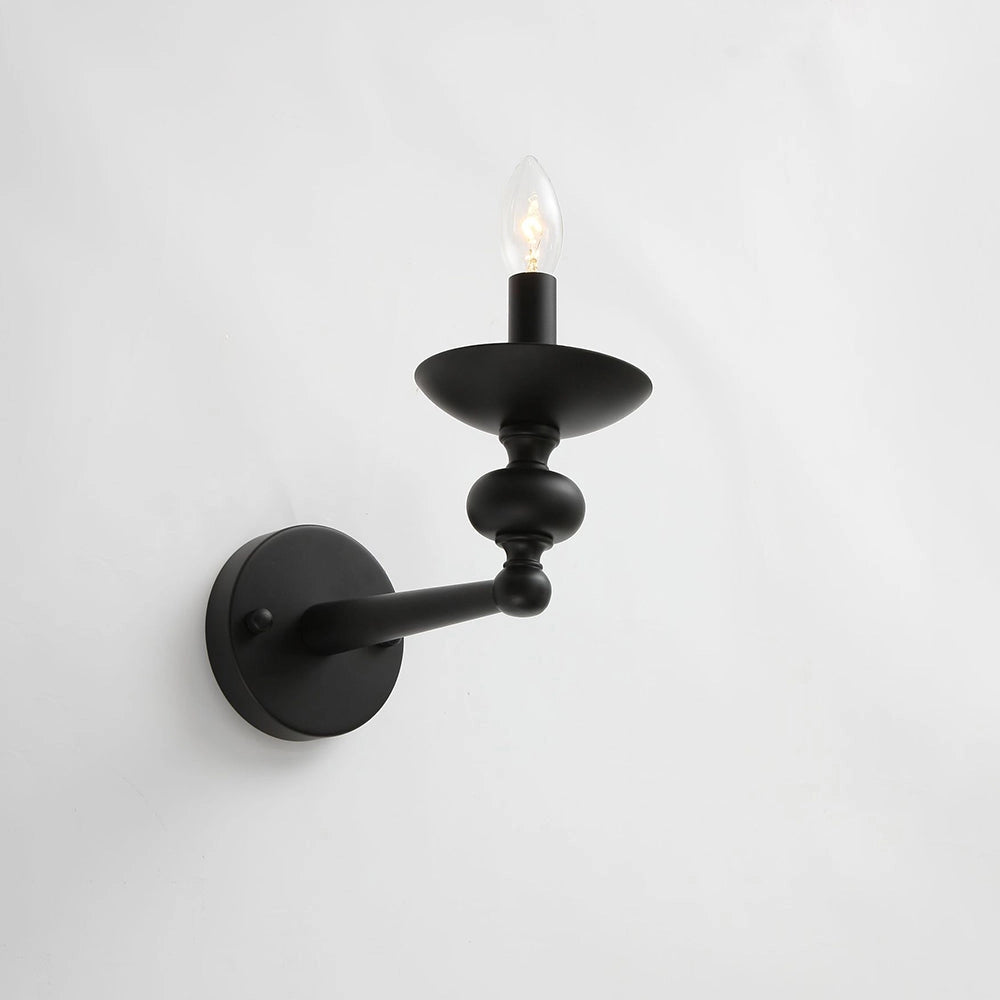 Modern black six-light candle chandelier with a sleek metal frame, hanging from the ceiling, showcasing elegant design and monochrome aesthetic.