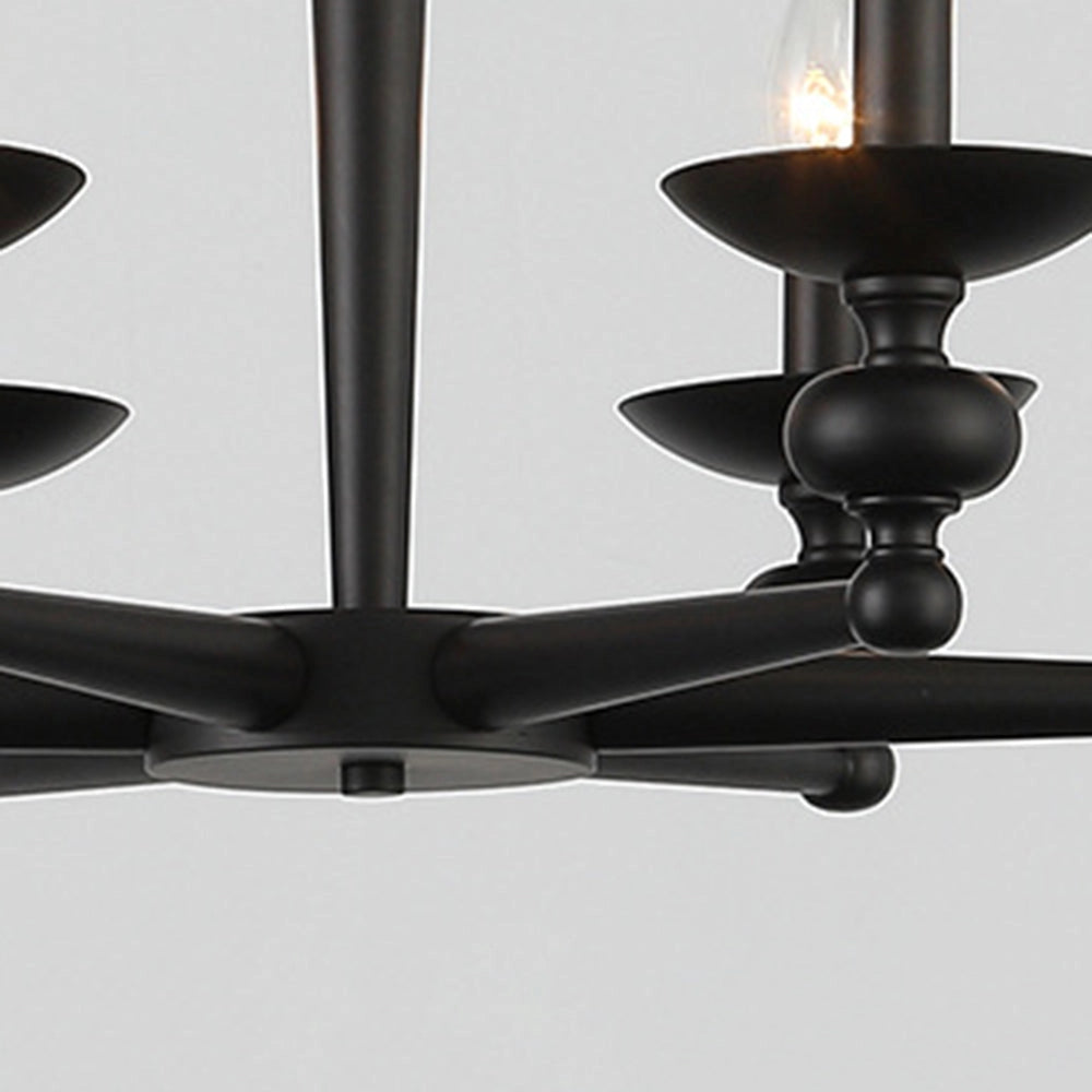 Modern black six-light candle chandelier with symmetrical design, featuring metal and glass elements, hanging from the ceiling over a table, providing elegant dining lighting with circular and rectangular accents.