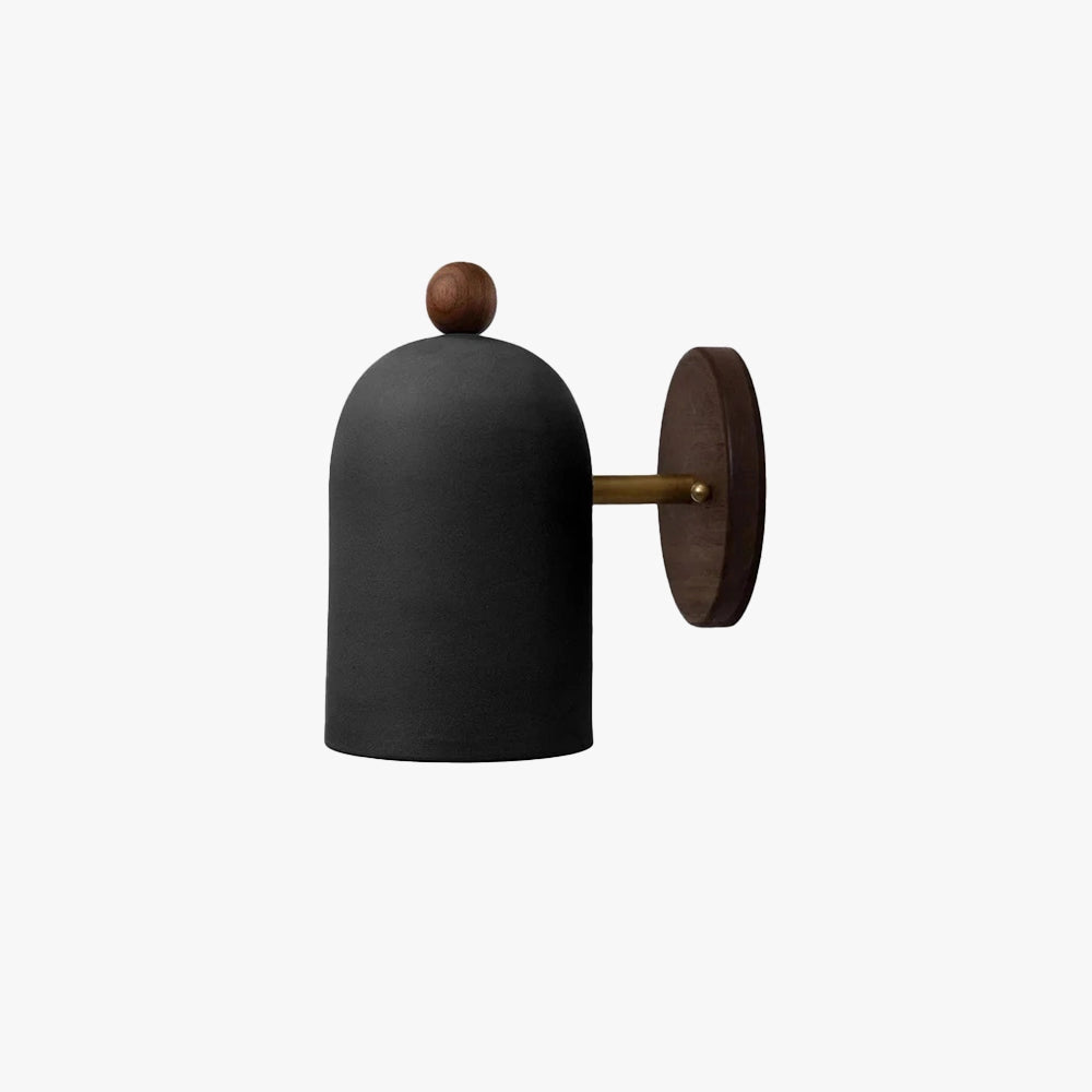 Modern black wall sconce with a minimalist industrial design, mounted on a textured wall.