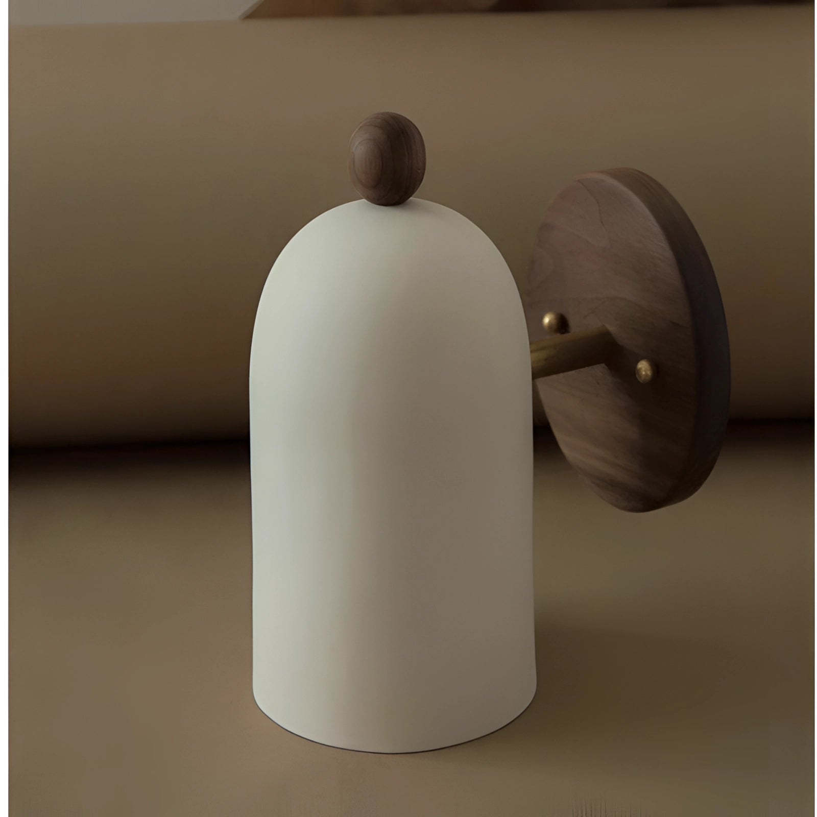 Modern black wall sconce with a minimalist industrial design, featuring a cylindrical white lamp shade and metal fixtures.
