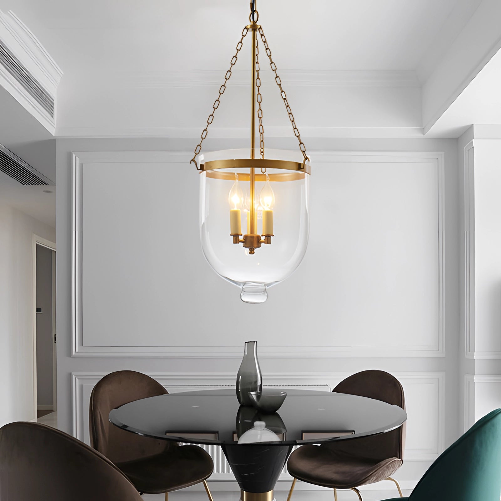 Modern brass glass pendant light hanging from the ceiling in a luxury indoor setting, illuminating a stylish living room with wooden flooring and contemporary interior design elements.