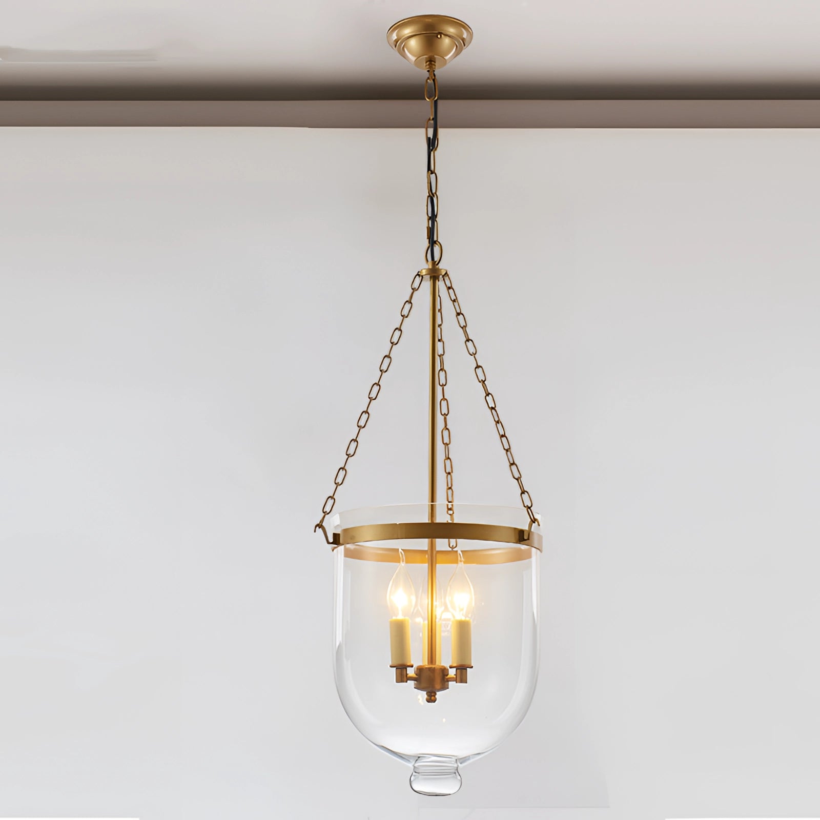 Modern brass and glass pendant light chandelier with amber-tinted glass shades and rectangular wooden accents, designed as a luxurious ceiling fixture for indoor spaces.