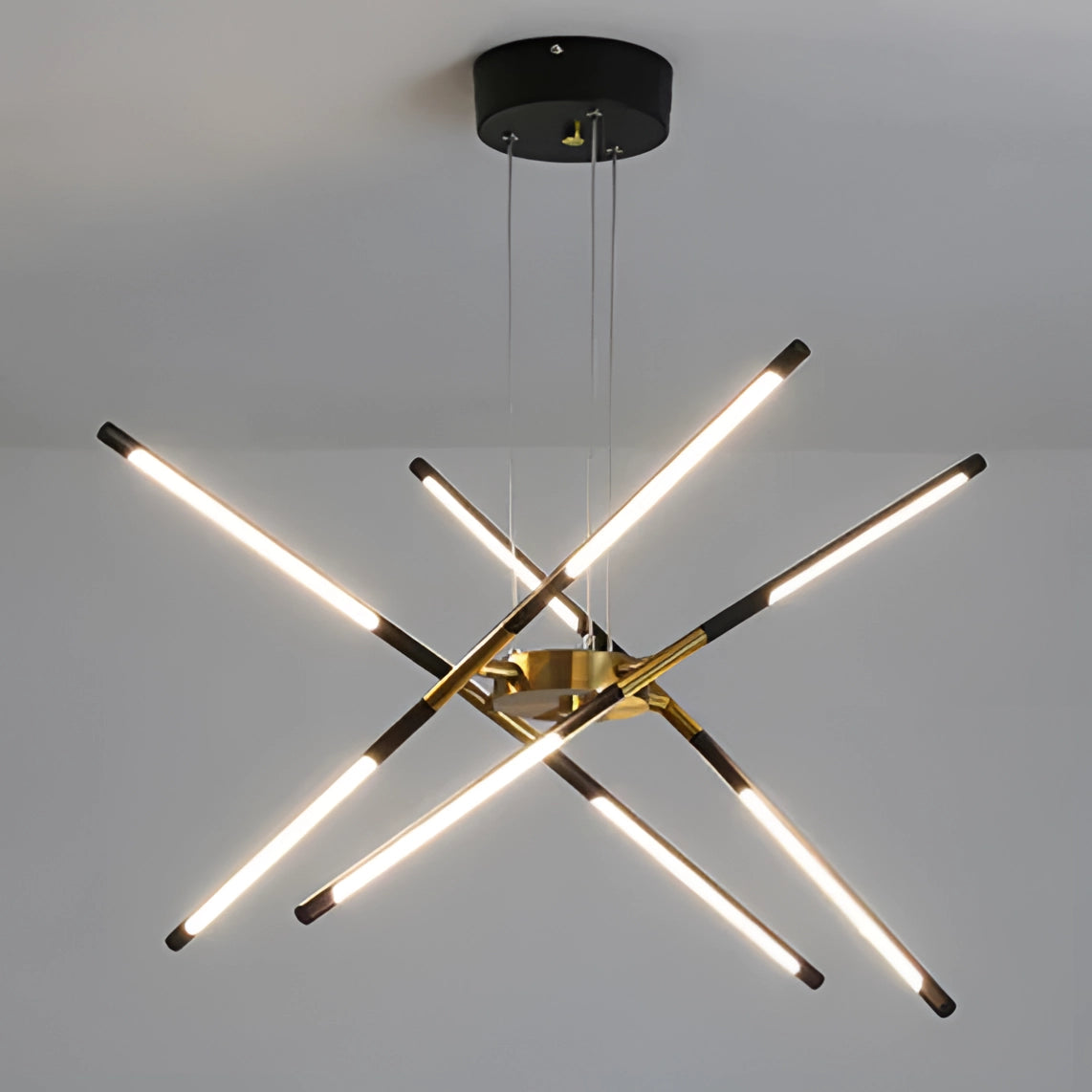 Modern brass LED chandelier with symmetrical design, featuring composite metal materials, installed on a ceiling, providing luxurious illumination for a dining room.