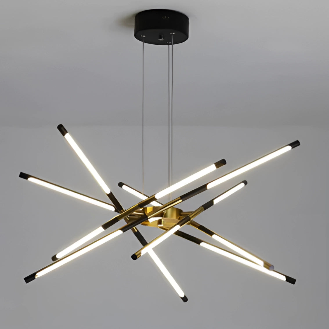 Modern brass LED chandelier with sleek design, featuring a luxurious finish, suspended in a sophisticated dining room setting.