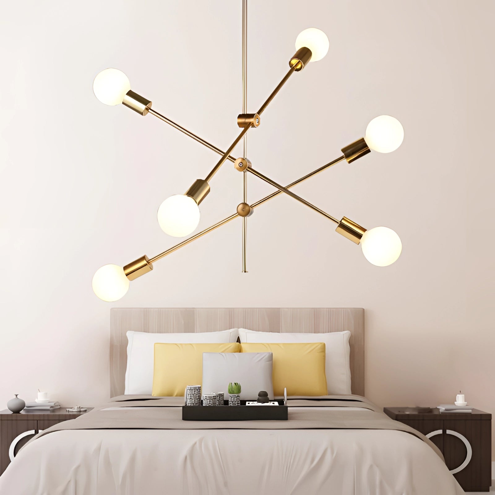 Modern brass Sputnik chandelier with mid-century adjustable geometric design, mounted on a white ceiling, illuminating a stylish interior with wooden accents and comfortable furniture.