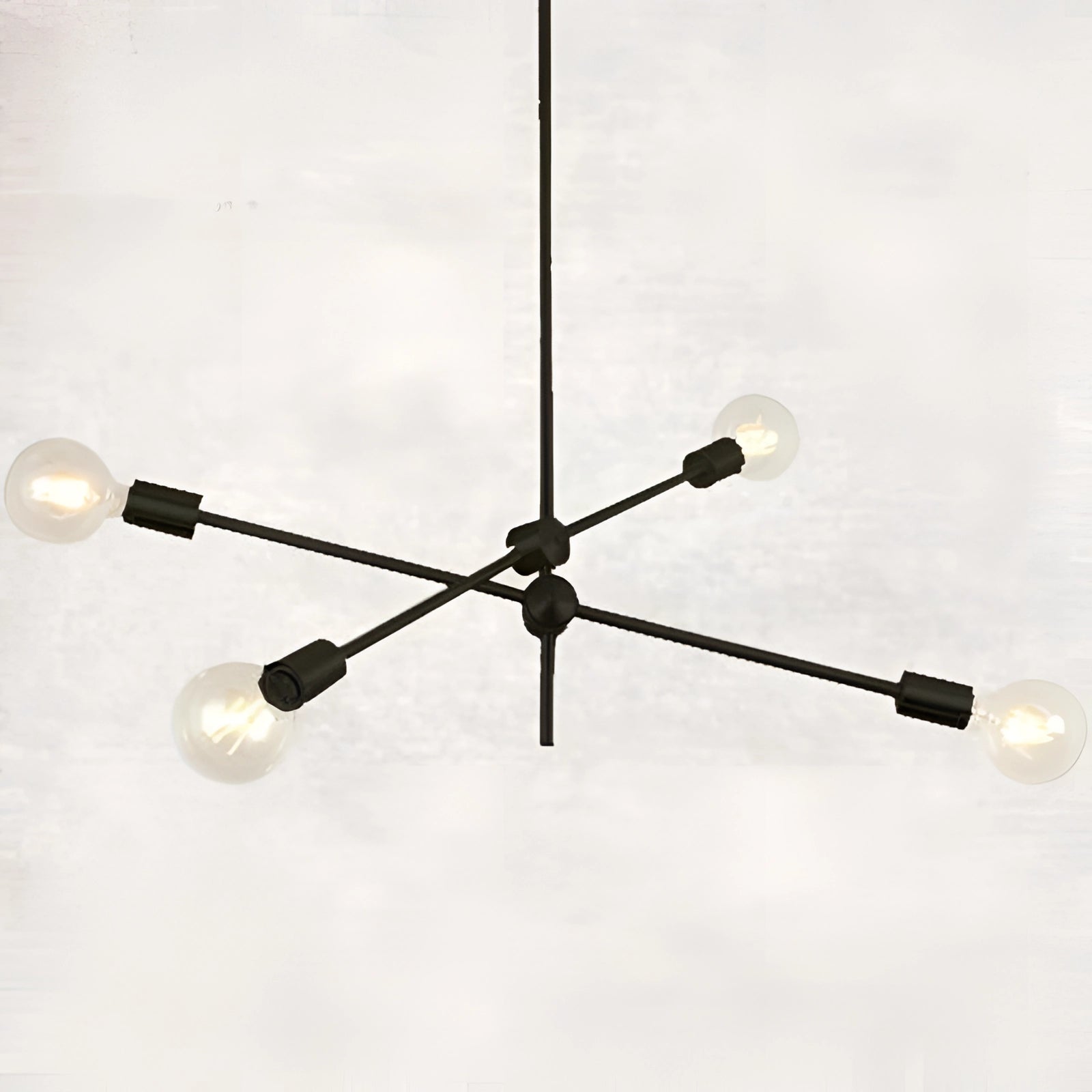 Modern brass Sputnik chandelier with four bulbs, mid-century adjustable geometric light in black finish, featuring a symmetrical metal design and ceiling mount.