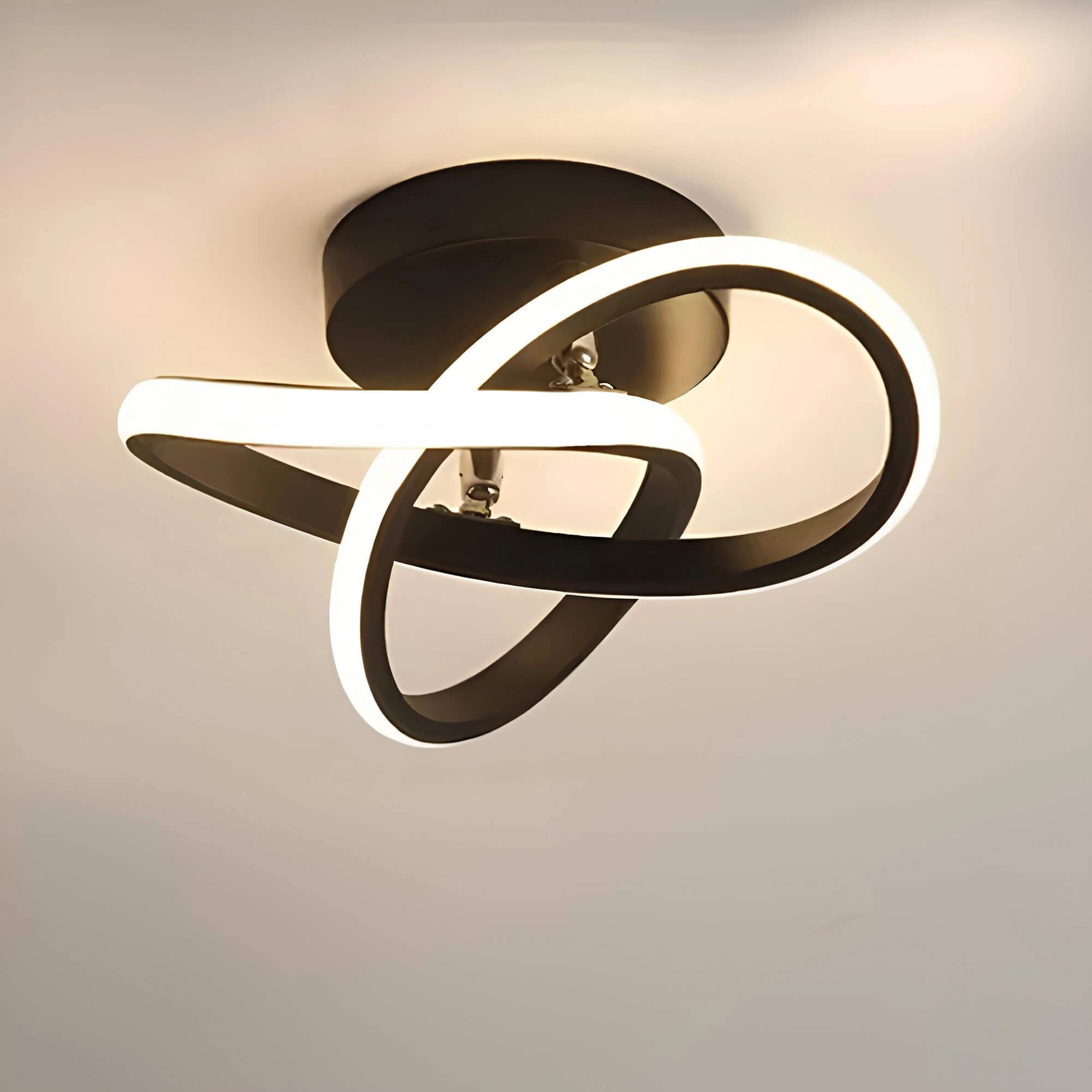 Circular LED ceiling light with a wavy black design, featuring a minimalist and modern aesthetic, showcasing a sleek and energy-efficient lighting solution.
