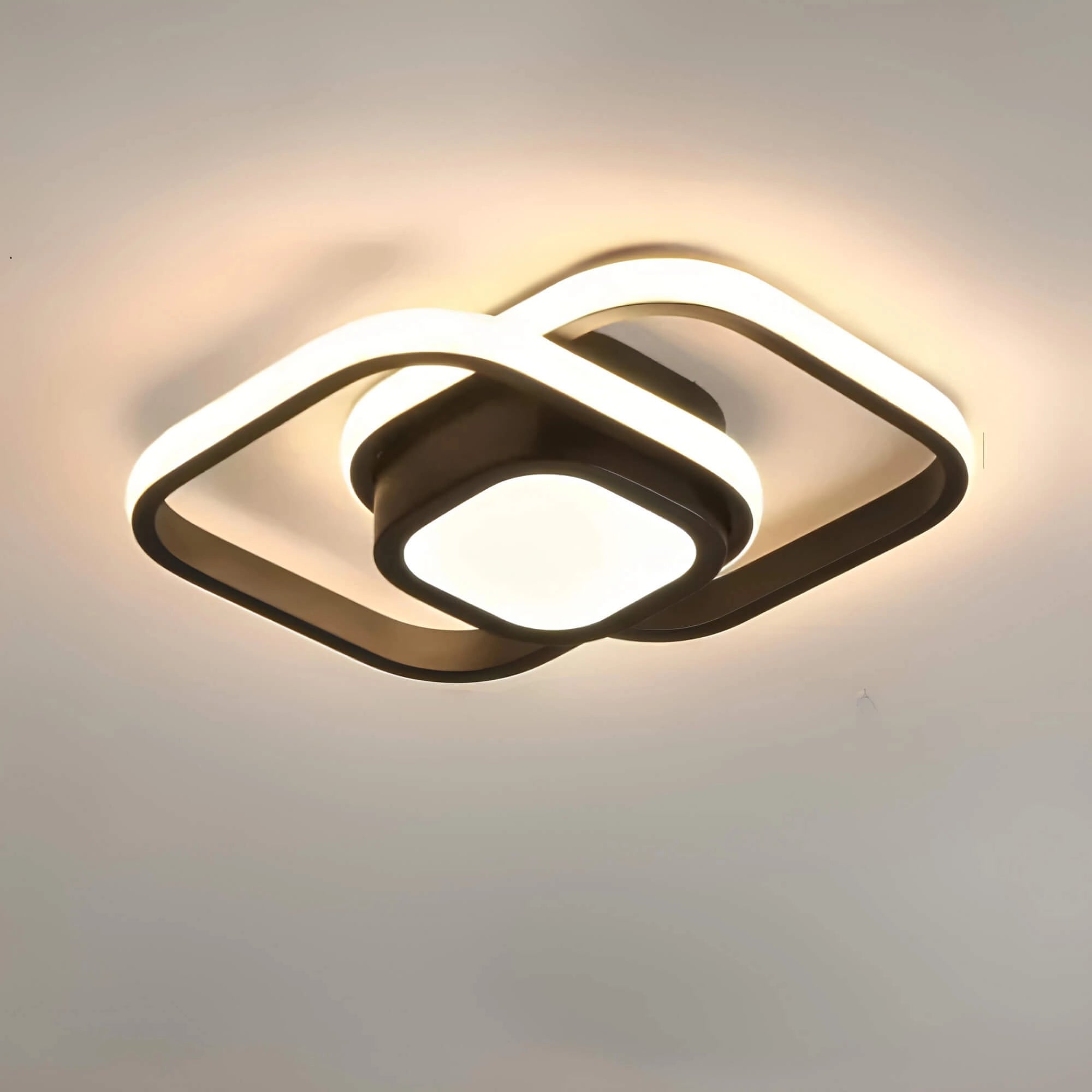 A modern square black LED ceiling light with a minimalist and energy-efficient design, featuring a sleek and contemporary aesthetic suitable for various interior spaces.