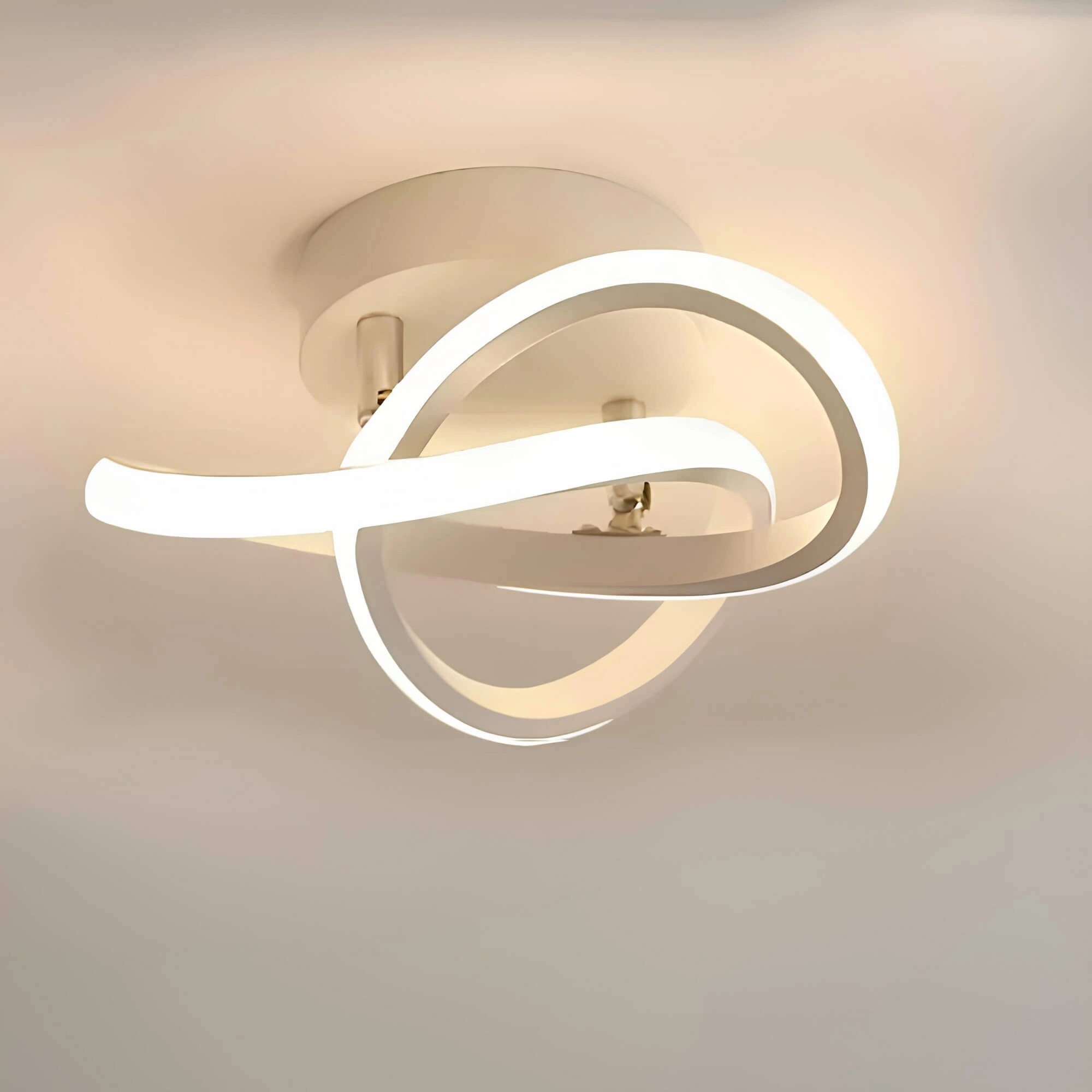 Modern circular LED ceiling light with a minimalist design featuring a wavy white finish, showcasing a sleek metal structure mounted on a ceiling.
