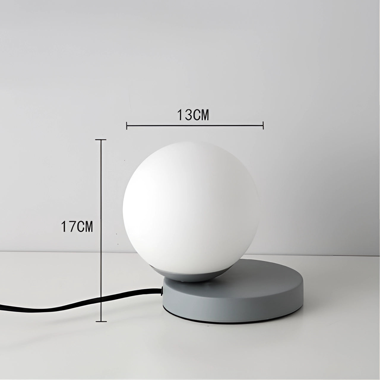 Modern designer orb lamp featuring a LED globe with a sleek metallic base, showcasing a spherical shape and symmetrical design.