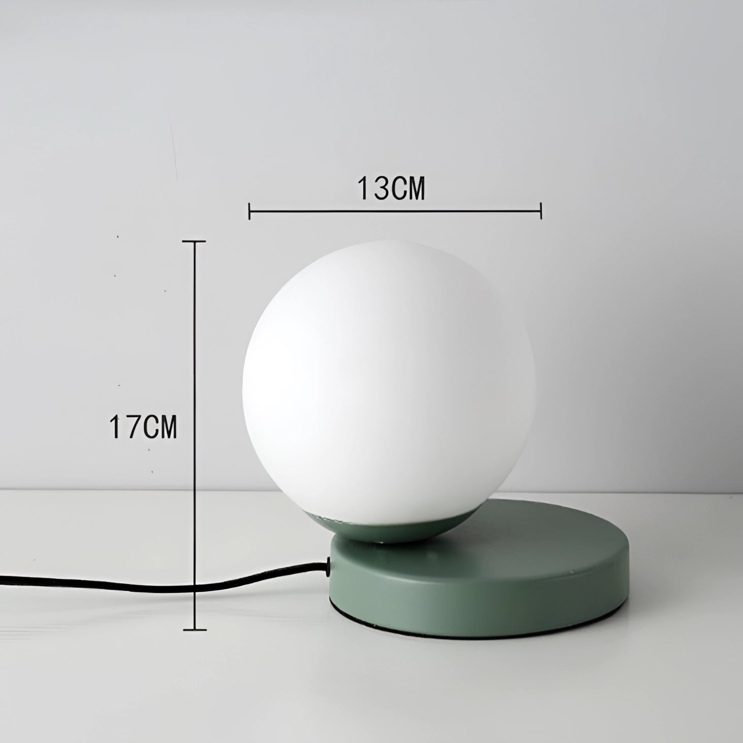 Modern designer orb lamp with a metallic base and LED globe, featuring a spherical light fixture.