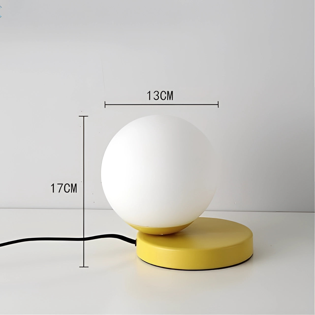 Modern Designer Orb Lamp with LED Globe, featuring a metallic base and a vibrant yellow finish, showcasing a sleek spherical design.