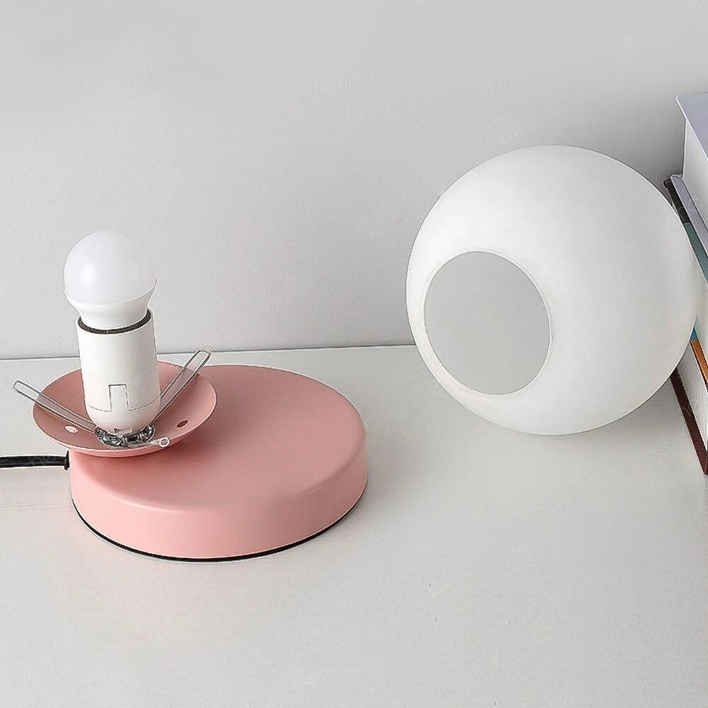 Modern designer orb lamp featuring a spherical LED globe with a sleek metallic base, placed on a table surface.