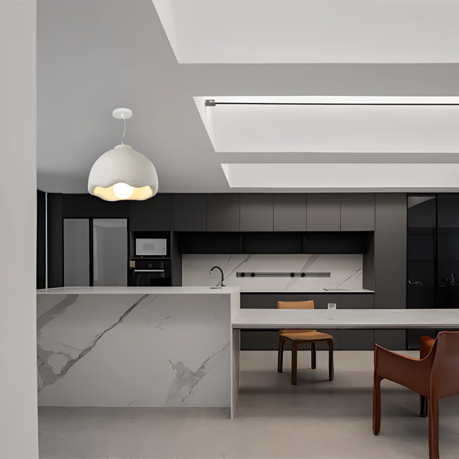 Modern dome pendant light with a textured white, scalloped design hanging above a kitchen countertop.