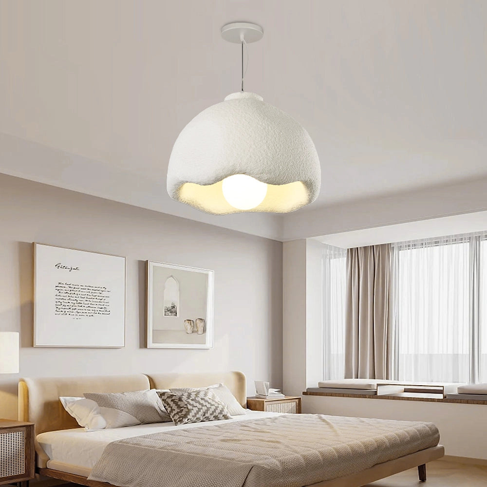 Modern dome pendant light with a textured white scalloped design, hanging in an elegant interior setting with wooden elements and nearby windows.
