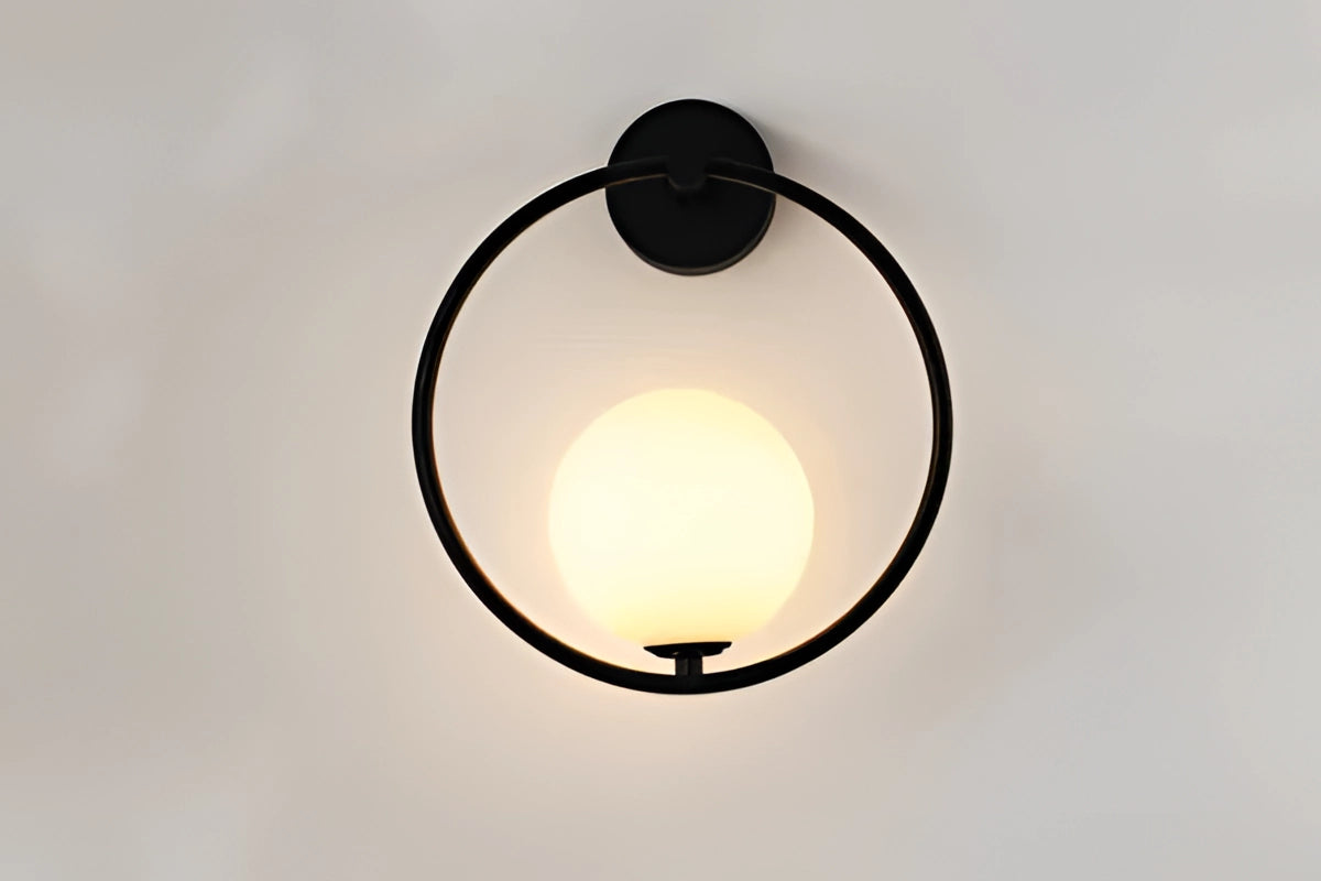 Modern dual globe brass wall sconces featuring a minimalistic design with two spherical light bulbs, mounted on a sleek brass base, ideal for enhancing contemporary interior spaces with ambient lighting.