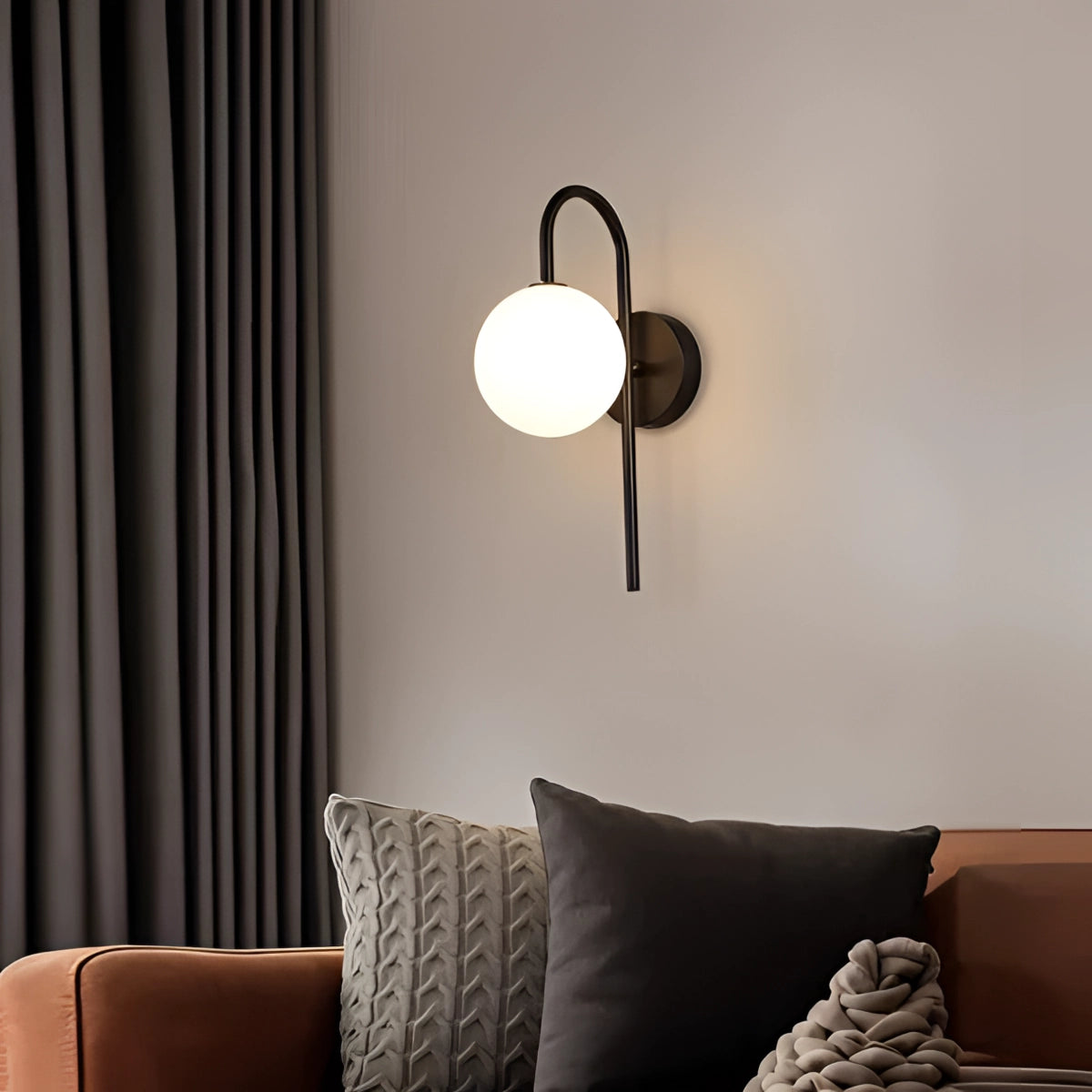 Modern dual globe brass wall sconces in neutral white and gold & white finish, measuring 12cm x 32cm, mounted on a wall in a stylish living room with wooden furniture.