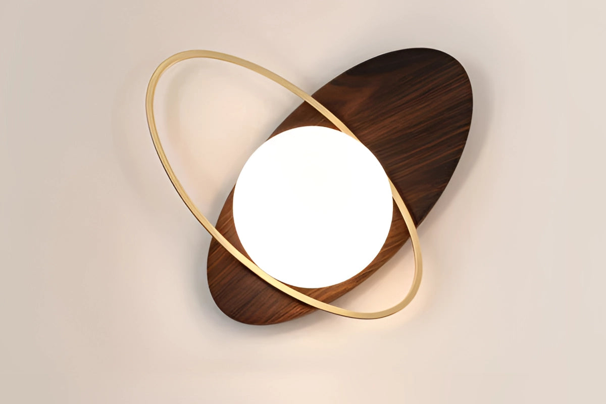 A pair of modern dual globe brass wall sconces with a minimalistic design, featuring spherical glass shades and a sleek brass finish. The sconces are mounted on a wooden backdrop, showcasing a chic and contemporary lighting decor for interior spaces.