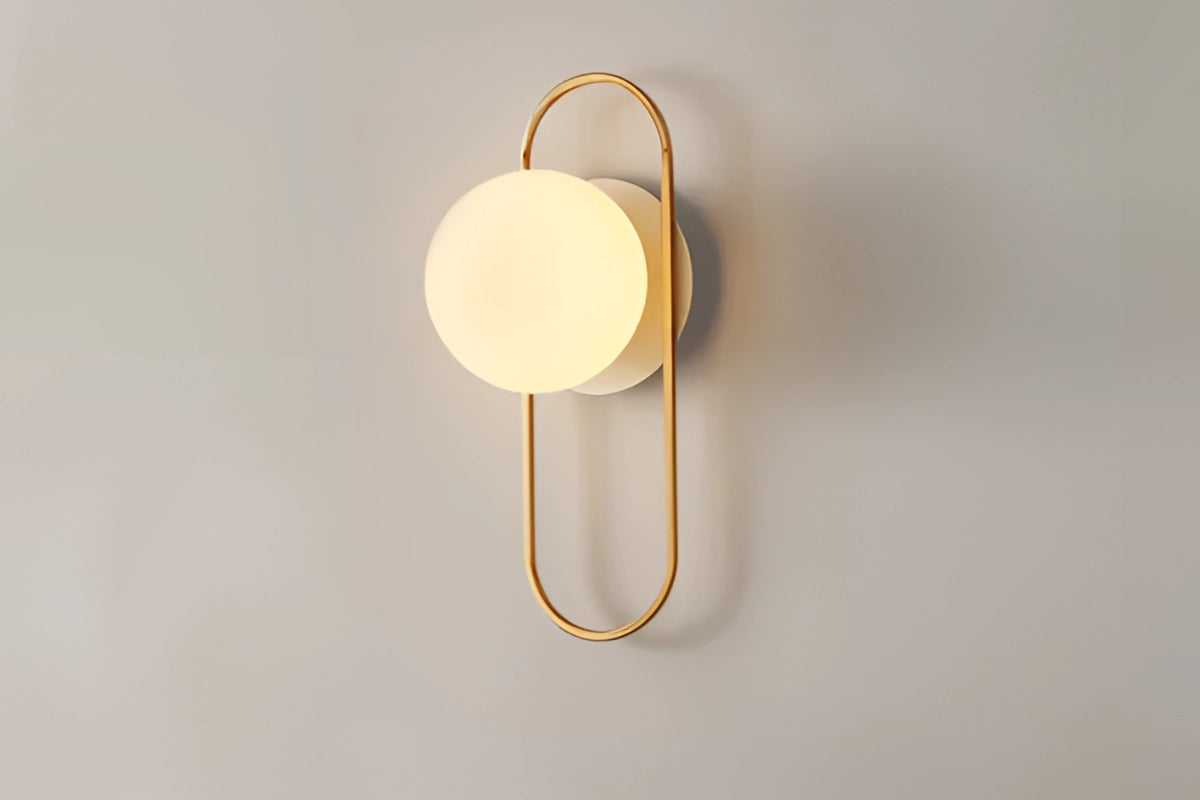 Minimalistic dual globe brass wall sconces with a modern design, featuring spherical light fixtures mounted on a sleek wooden base, suitable for stylish interior decor and ambient lighting.