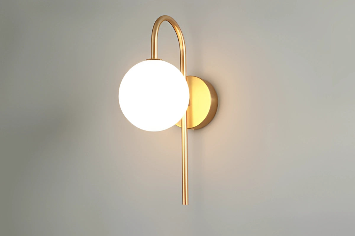 Modern dual globe brass wall sconces with amber-tinted glass globes, minimalist design, featuring circular metal accents and wooden elements, suitable for ceiling or wall installation.