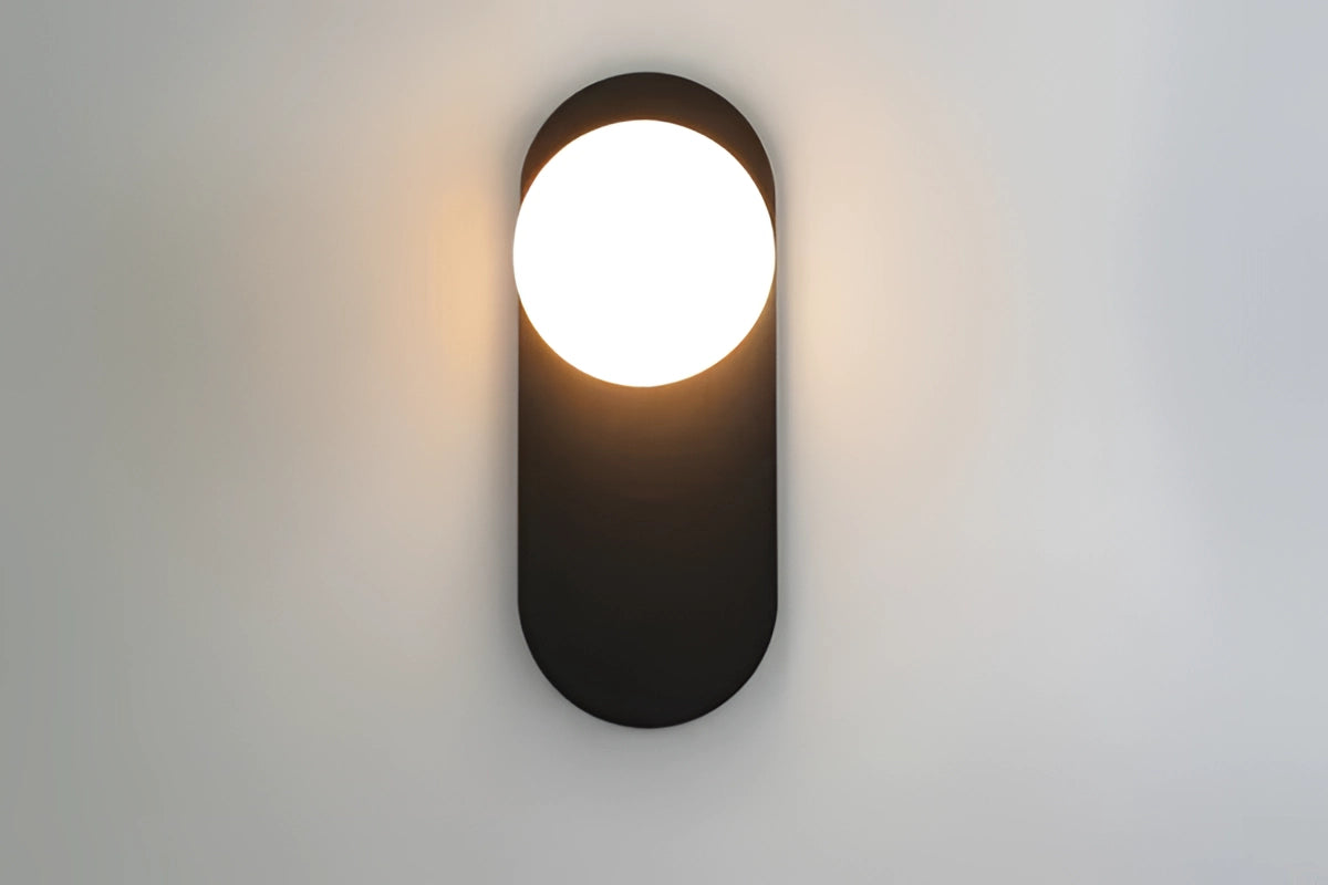 Modern dual globe brass wall sconce mounted on wood panel, featuring minimalistic design with warm light illuminating the space.