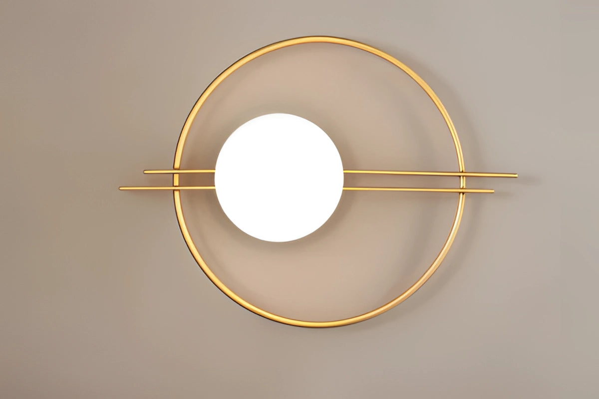 Modern dual globe brass wall sconces with a minimalistic design, featuring two spherical light fixtures mounted on a sleek metal base against a backdrop of wooden accents and artistic patterns.