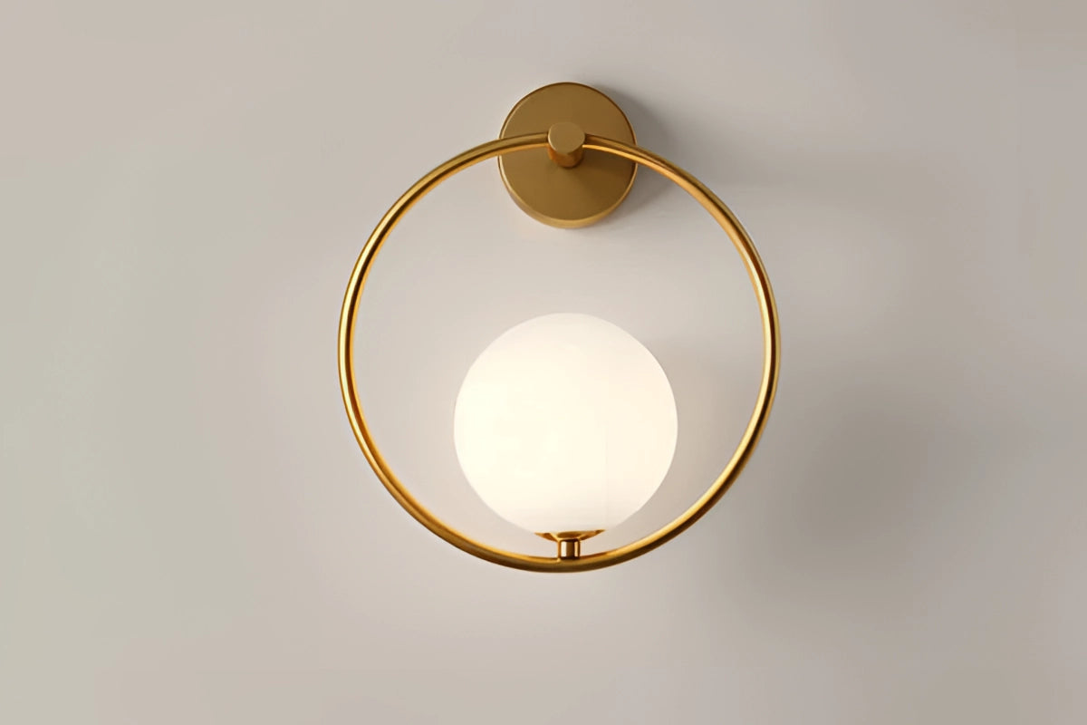 Modern dual globe brass wall sconce featuring spherical amber-colored glass shades, providing a minimalistic and elegant lighting decor. The fixture is made of metal and designed to mount seamlessly on the wall, offering a subtle yet stylish illumination.