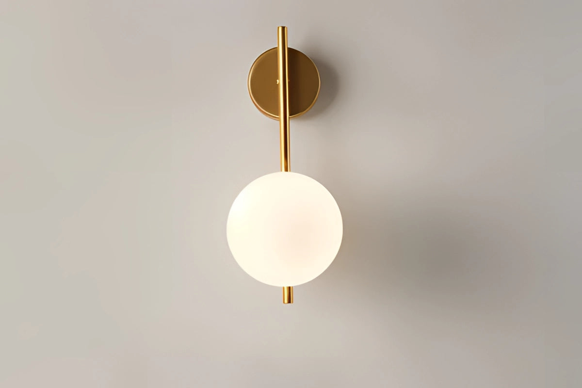Modern dual globe brass wall sconce with a sleek and minimalistic design, featuring two spherical clear glass shades mounted on a brass fixture, ideal for contemporary interior lighting decor.