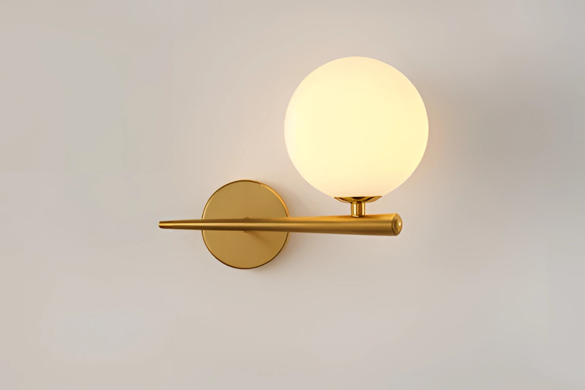 Modern dual globe brass wall sconces featuring a minimalistic design with two circular metal globes, mounted against a wooden backdrop.