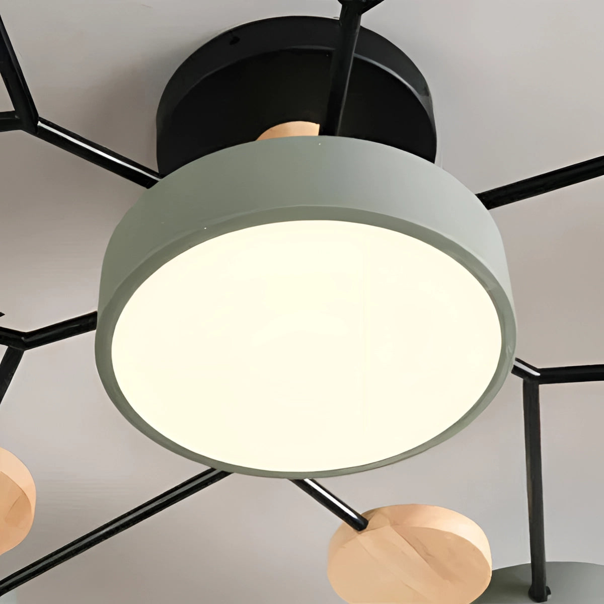 Modern geometric chandelier featuring a matte black and wood finish with multiple bulbs, designed as a ceiling fixture with circular and linear elements, offering stylish and contemporary lighting.