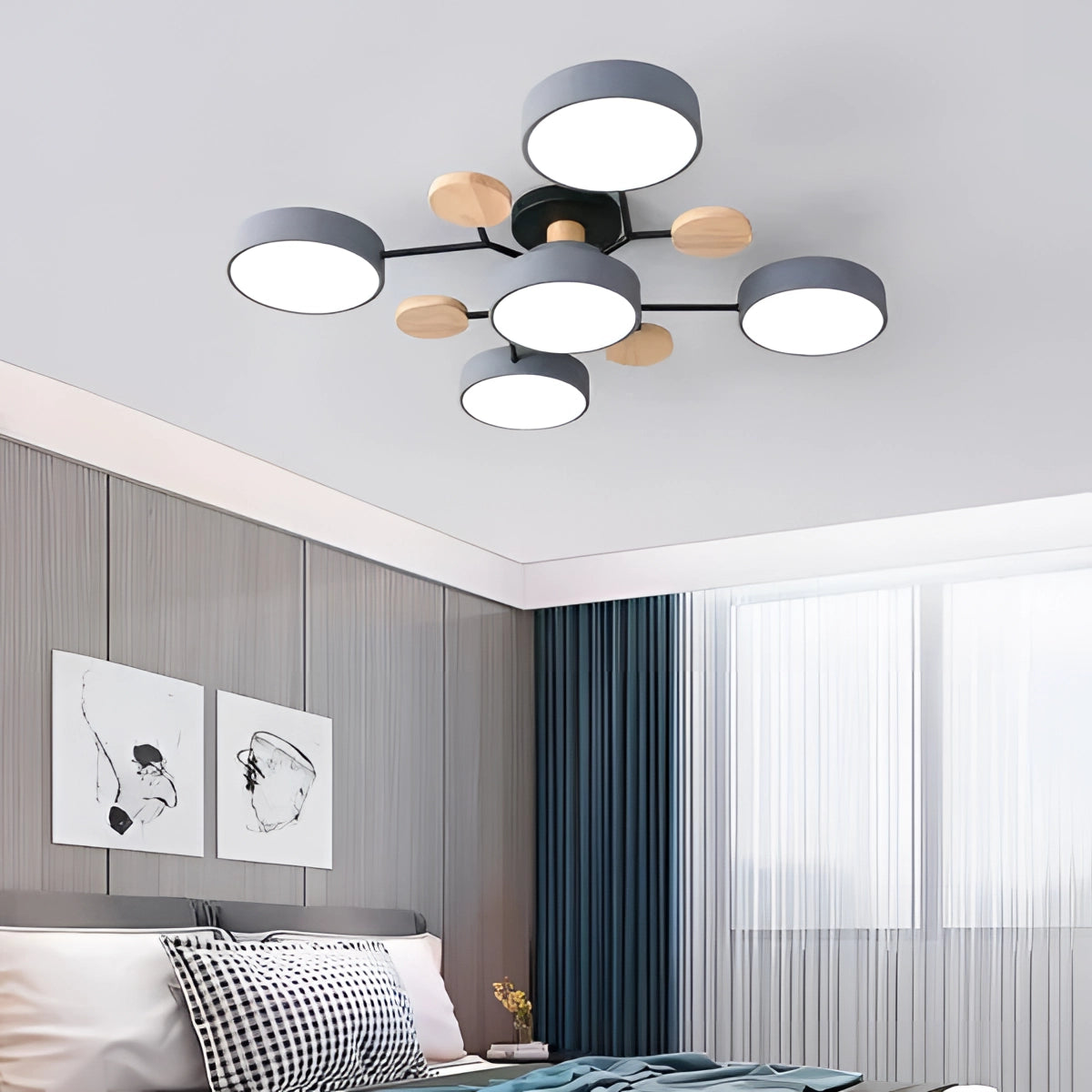 A modern geometric chandelier with a matte black and wood finish, featuring multiple bulbs, hanging in a stylish interior space with a white and grey color scheme.