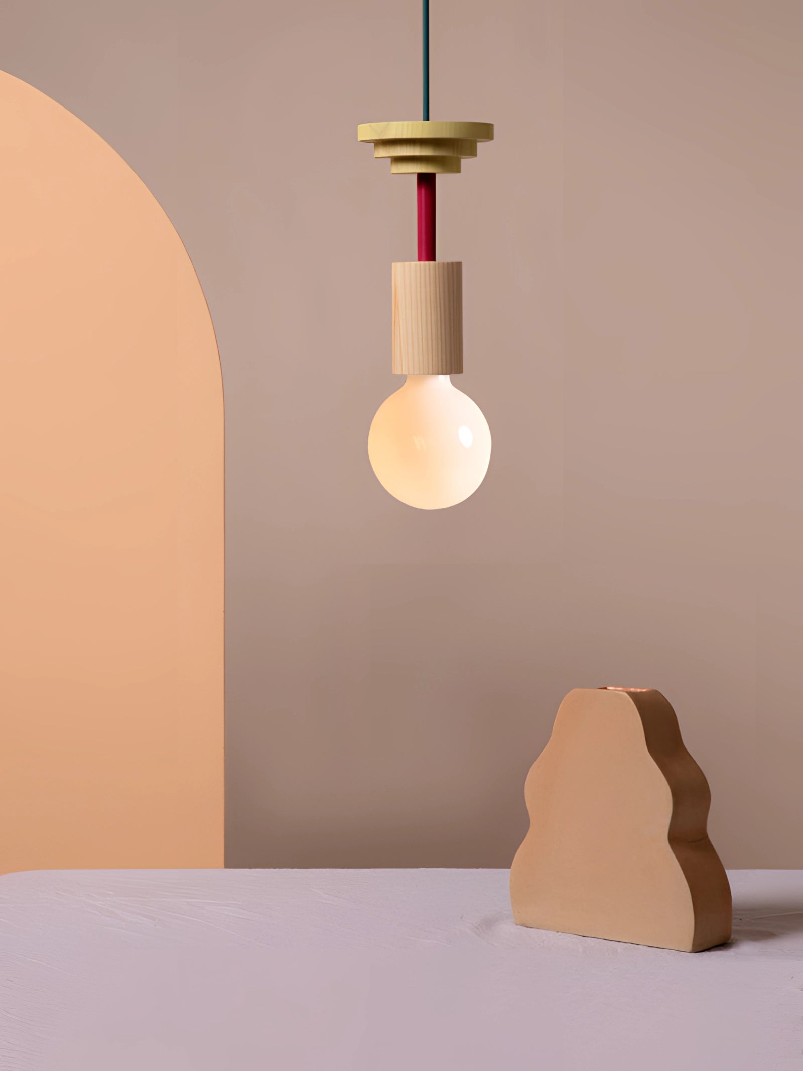 Modern geometric LED pendant light featuring colorful wood blocks, suspended from the ceiling, illuminating the room.