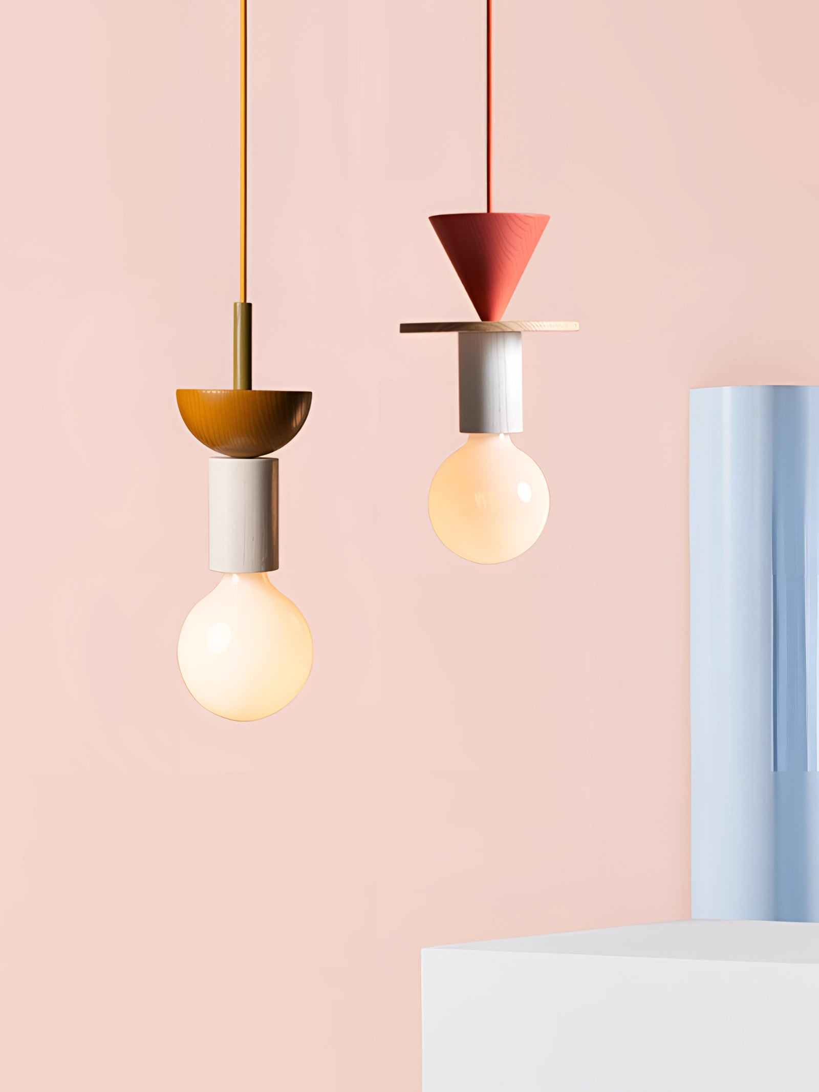 Modern geometric LED pendant light with colorful wood blocks hanging from the ceiling.