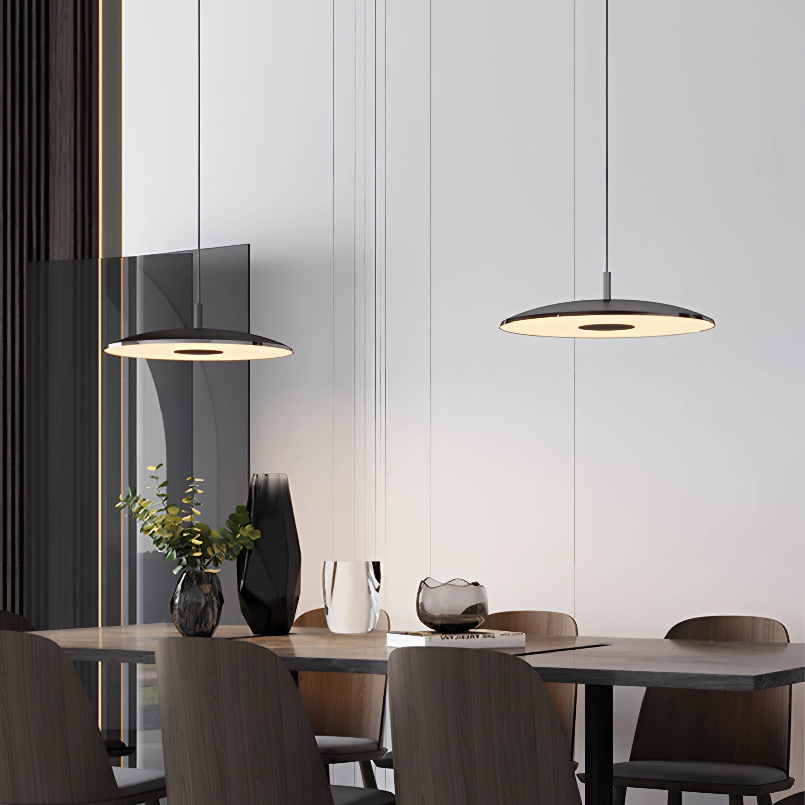 Modern gold-brushed pendant light with a sleek design, featuring a nickel finish and a diameter of 15.7 inches, hanging above a wooden dining table in a contemporary interior setting.