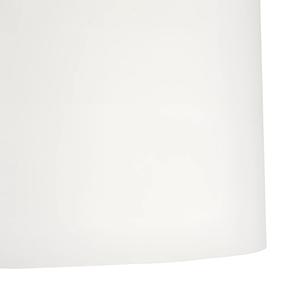 Modern gold floor lamp with white shade, featuring elegant vertical rods, standing in a minimalist setting.