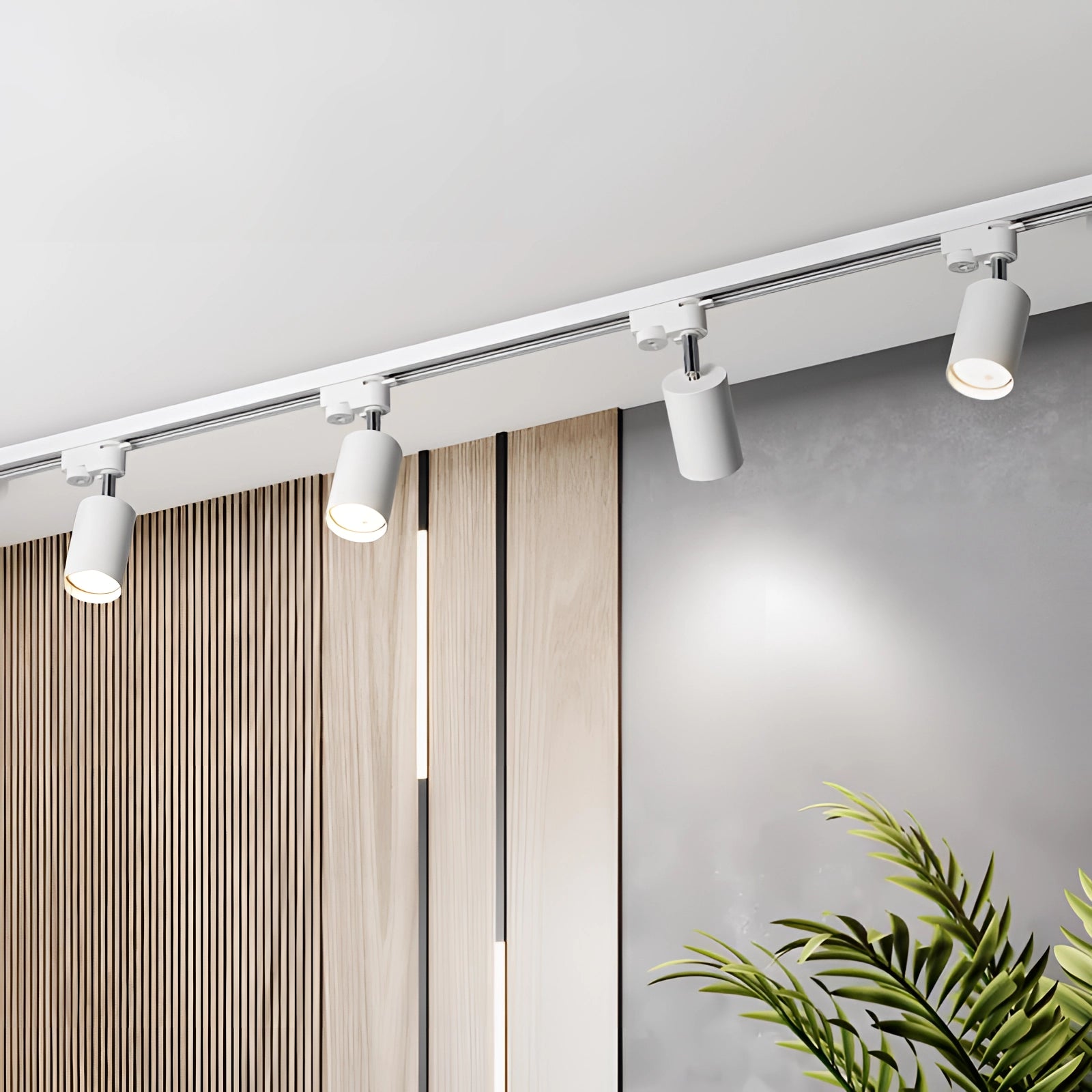 Modern LED track lighting fixture installed on a ceiling in a room with plants, wooden accents, and textile curtains by the windows, showcasing an interior design focused on natural materials and adjustable lighting solutions.
