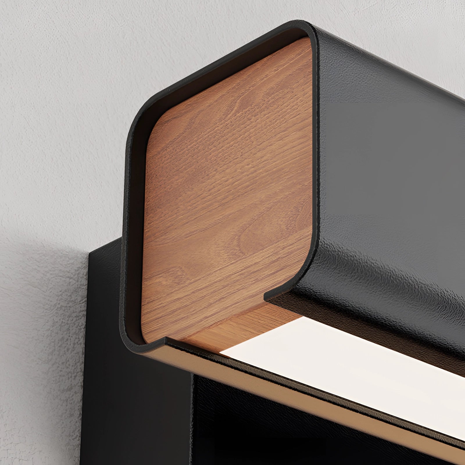 Modern LED wall sconce featuring a sleek black and gold design with a rectangular shape, set against a wood-textured background.