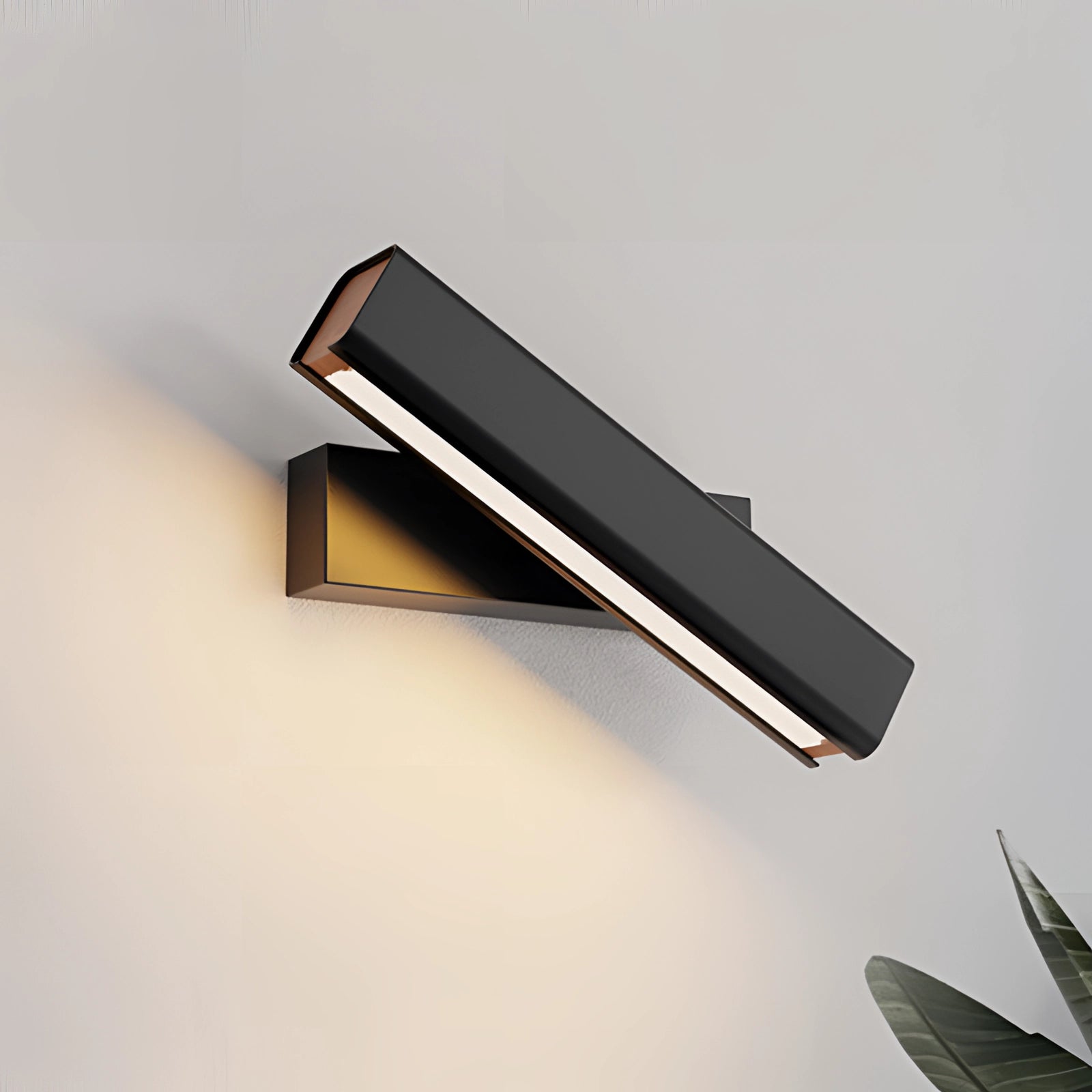 Modern LED wall sconce featuring an adjustable black and gold design with a sleek, contemporary look. The lamp's structure includes rectangular elements and metal accents, ideal for stylish home decor.