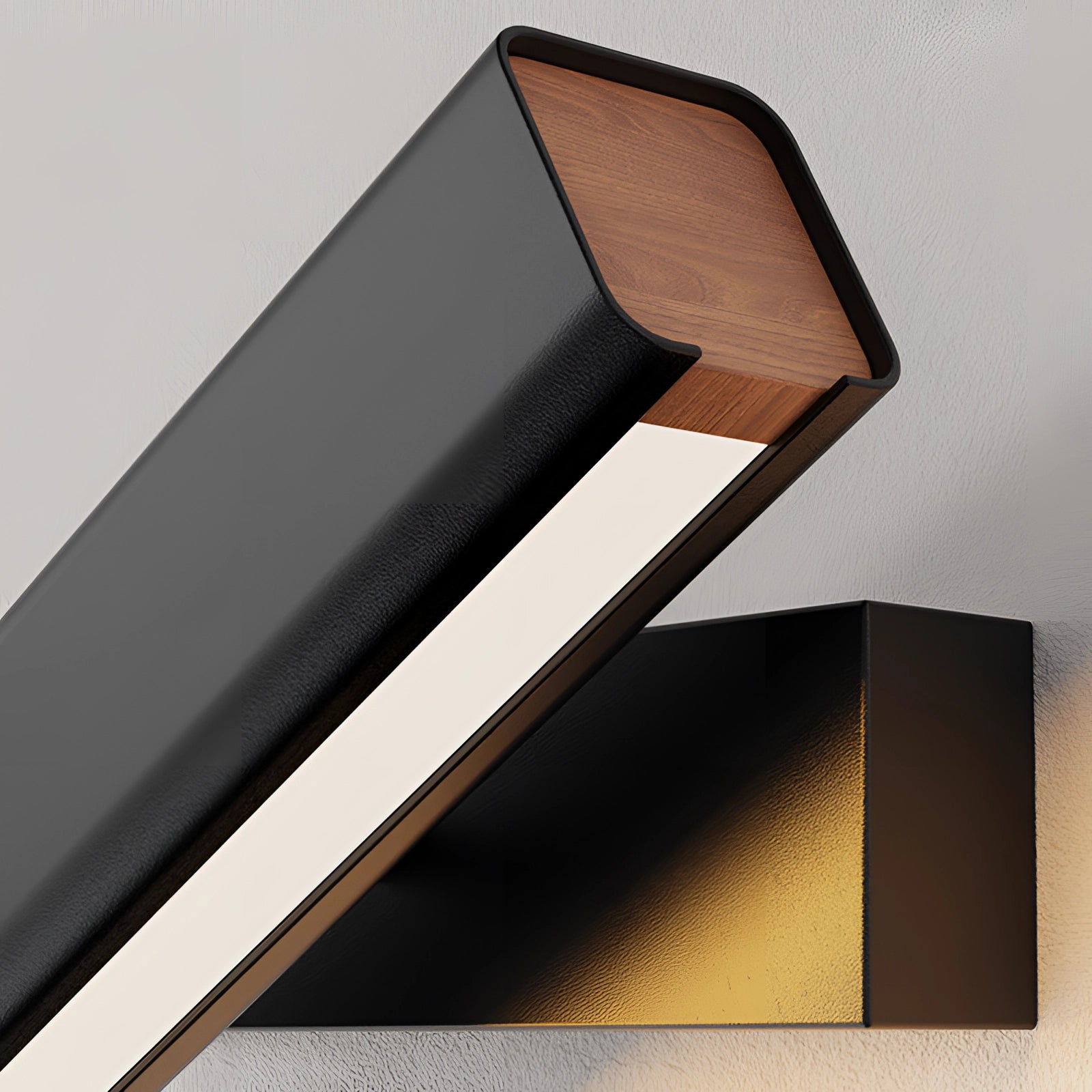 Modern LED wall sconce featuring a sleek black and gold design with adjustable elements, mounted on a rectangular wooden base. The contemporary lamp combines metal and wood materials for a stylish, art-inspired look.