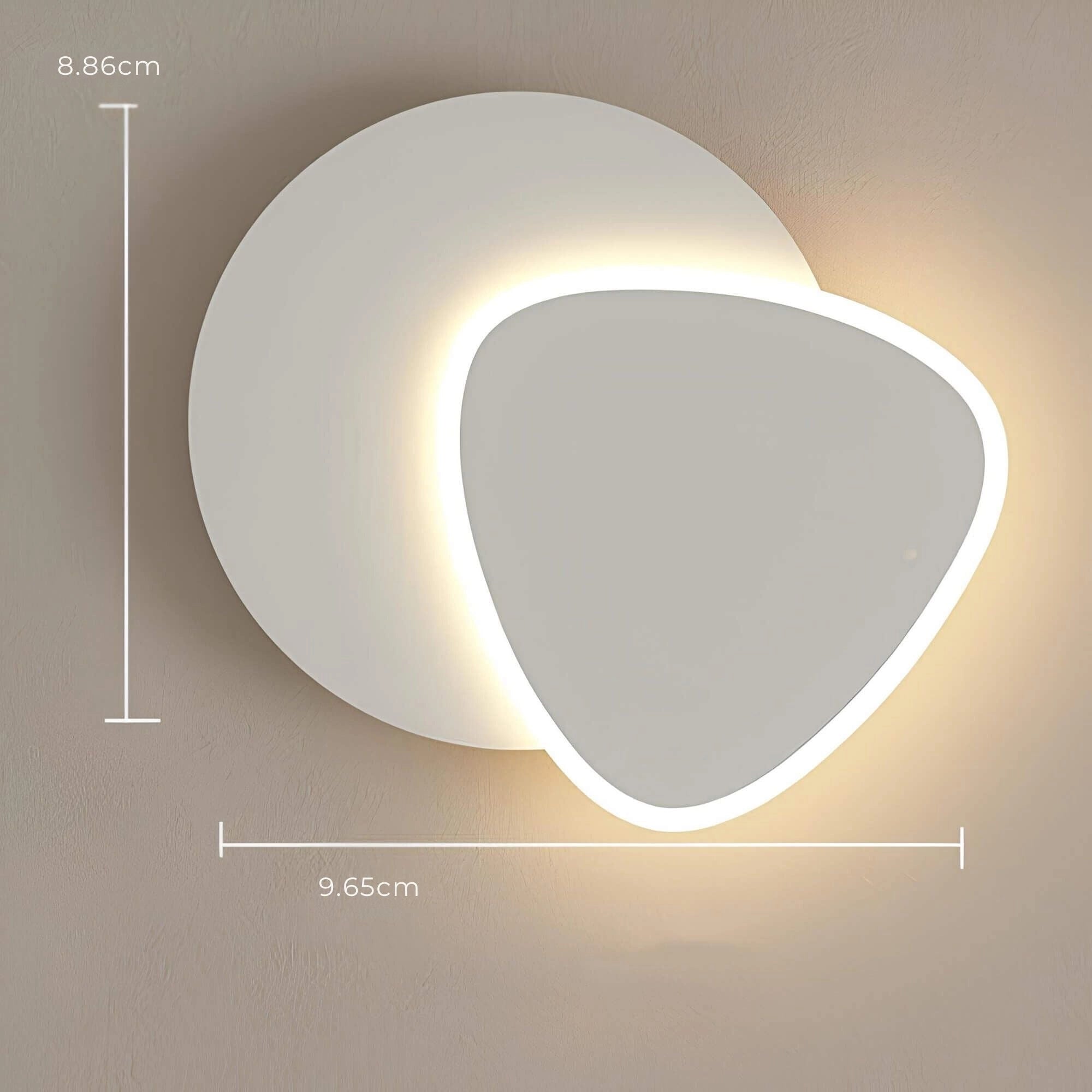 Modern LED wall sconce with a geometric minimalist design featuring circular and rectangular elements, mounted on an indoor wall, providing ambient lighting.