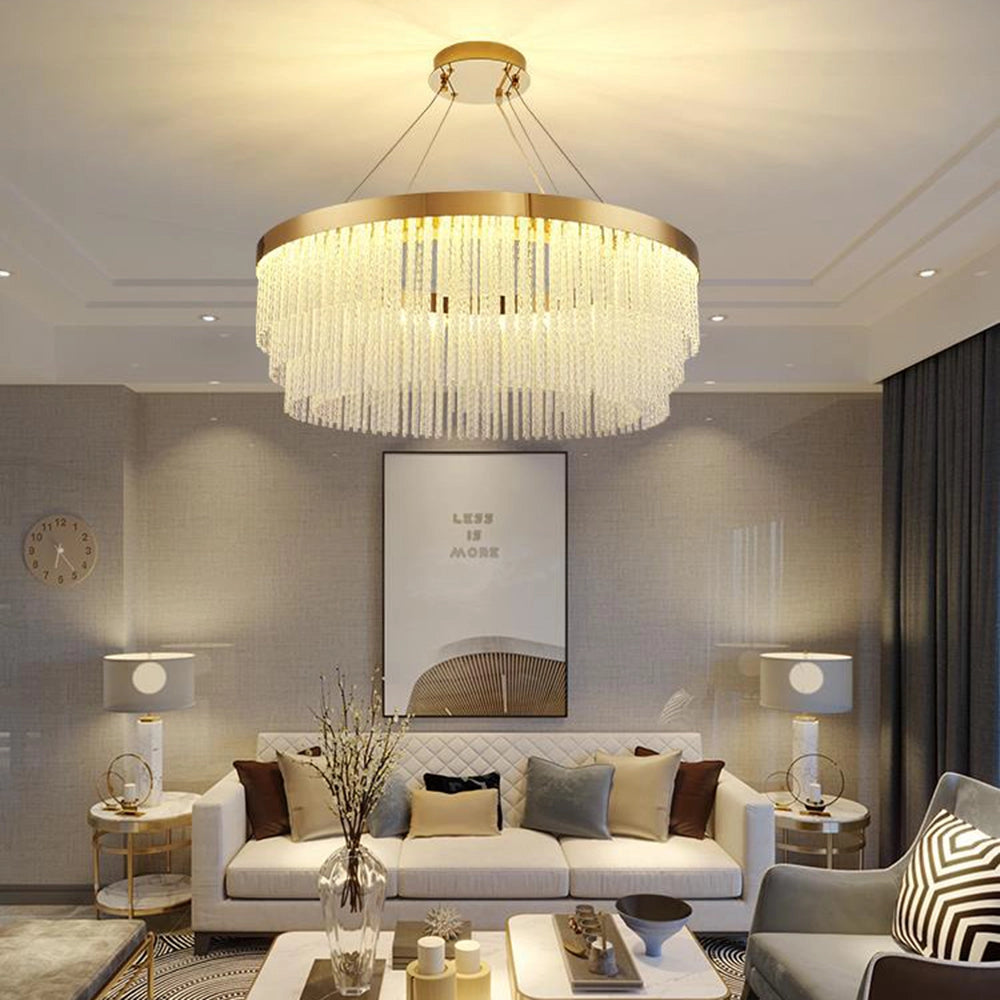 Modern luxury circular crystal LED chandelier with a brass finish, measuring 39.3 inches, elegantly hanging in a well-decorated interior above a stylish table and couch setup.