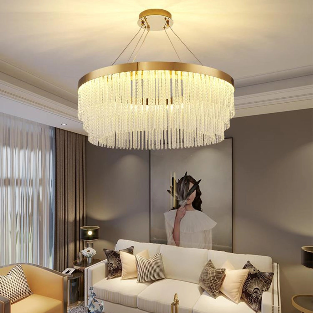 A modern luxury circular crystal LED chandelier with a brass finish, measuring 15.7 inches, elegantly suspended above a stylishly decorated living room.