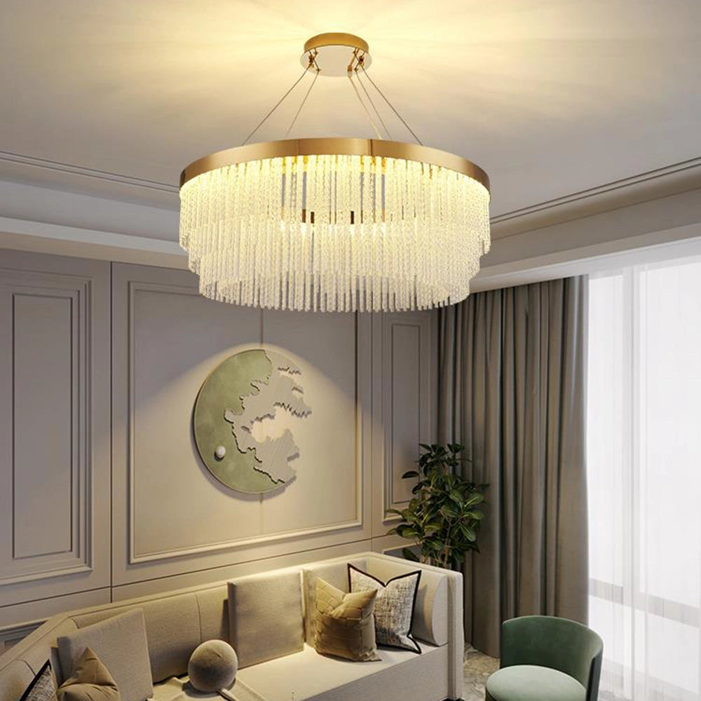 Modern luxury circular crystal LED chandelier with a brass finish, measuring 31.5 inches, hanging elegantly above a table in a well-designed interior space.