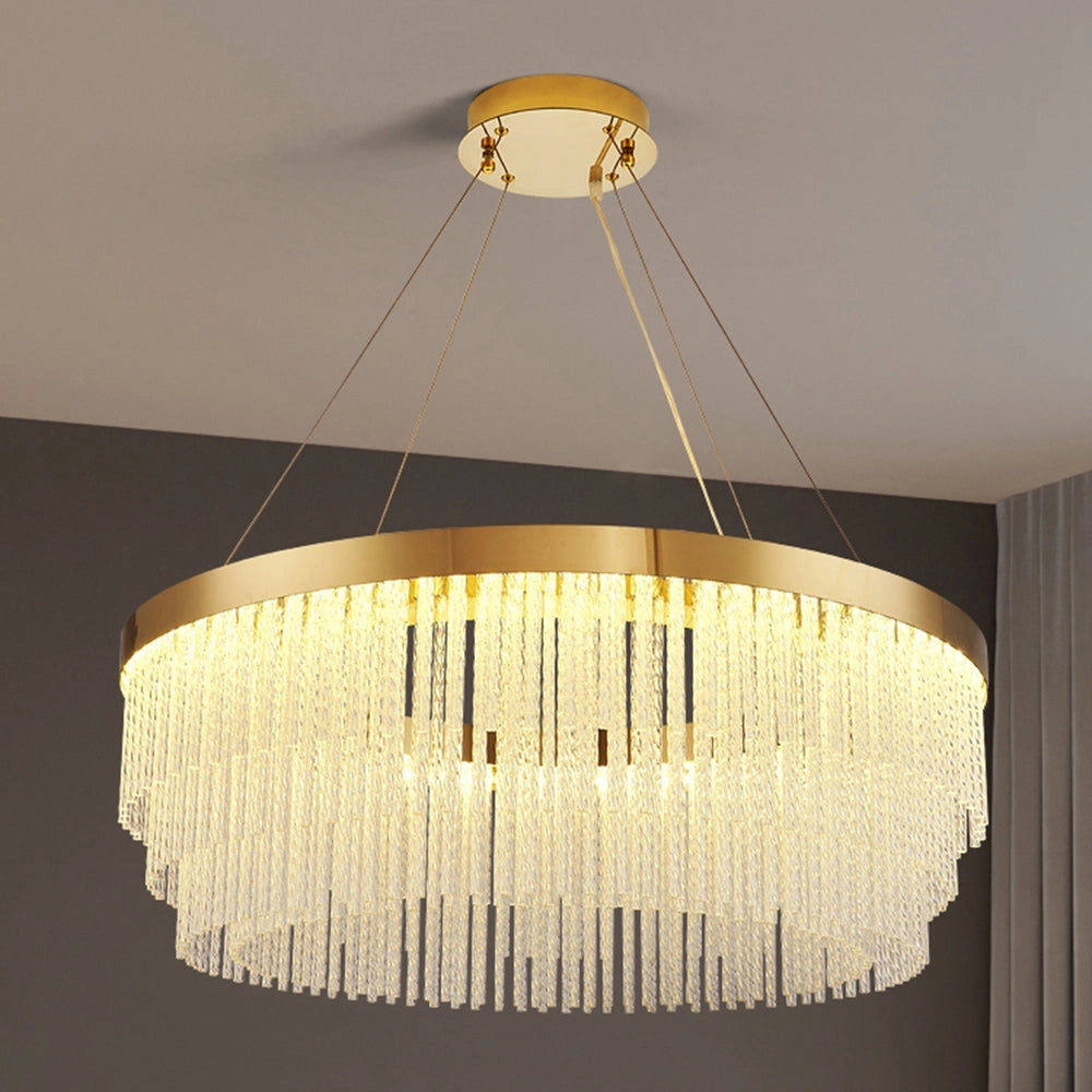 Modern luxury circular crystal LED chandelier with a brass finish, elegantly suspended in a sophisticated interior setting. The chandelier features a sleek design with crystal elements that reflect and diffuse light, enhancing the room's ambiance.