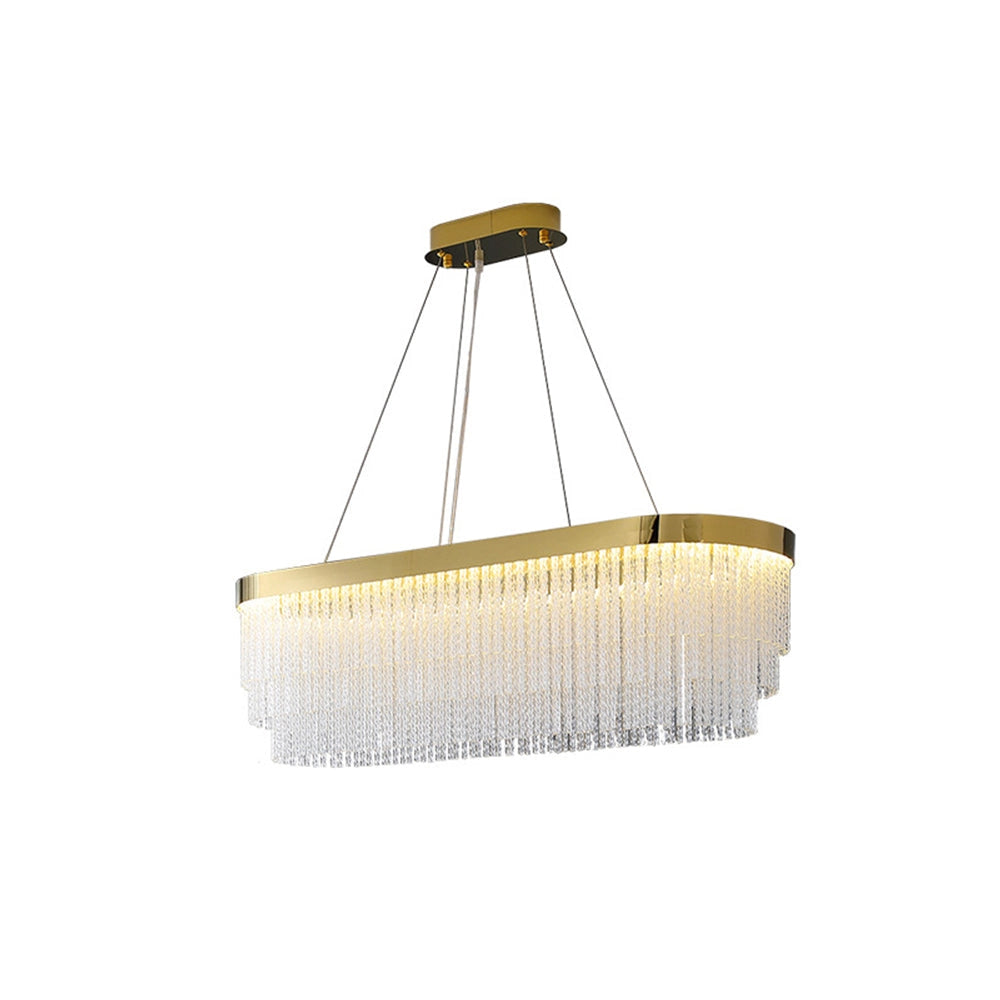 Modern luxury circular crystal LED chandelier with brass finish, suspended from the ceiling, illuminating a sleek wooden table below.