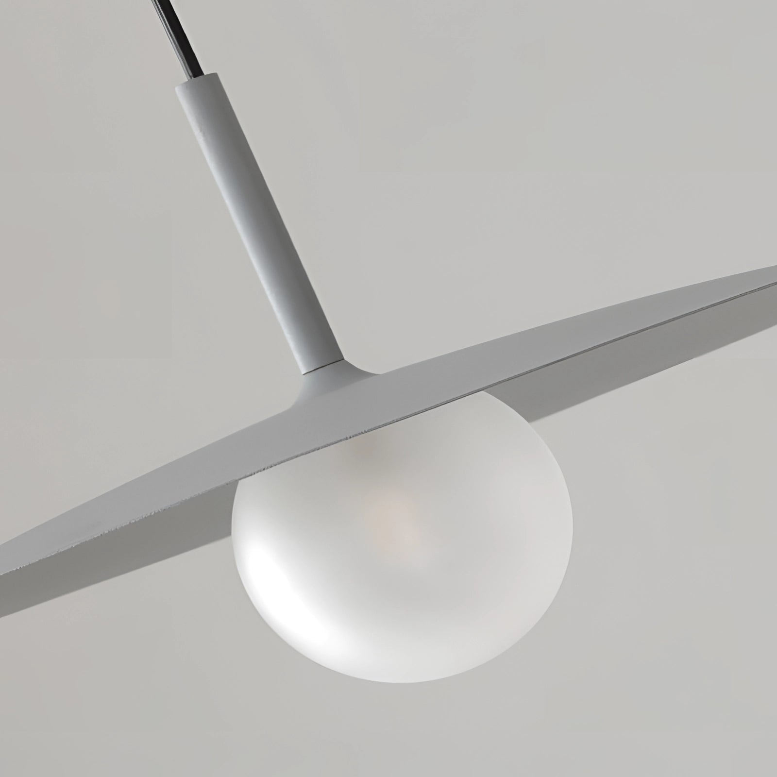 Modern minimalist LED pendant light with a Scandinavian dual-tone design, featuring a circular shape suspended from the ceiling. The fixture is crafted from composite materials, including metal elements such as nickel, titanium, steel, and aluminum, showcasing symmetry in its sleek and artful design.