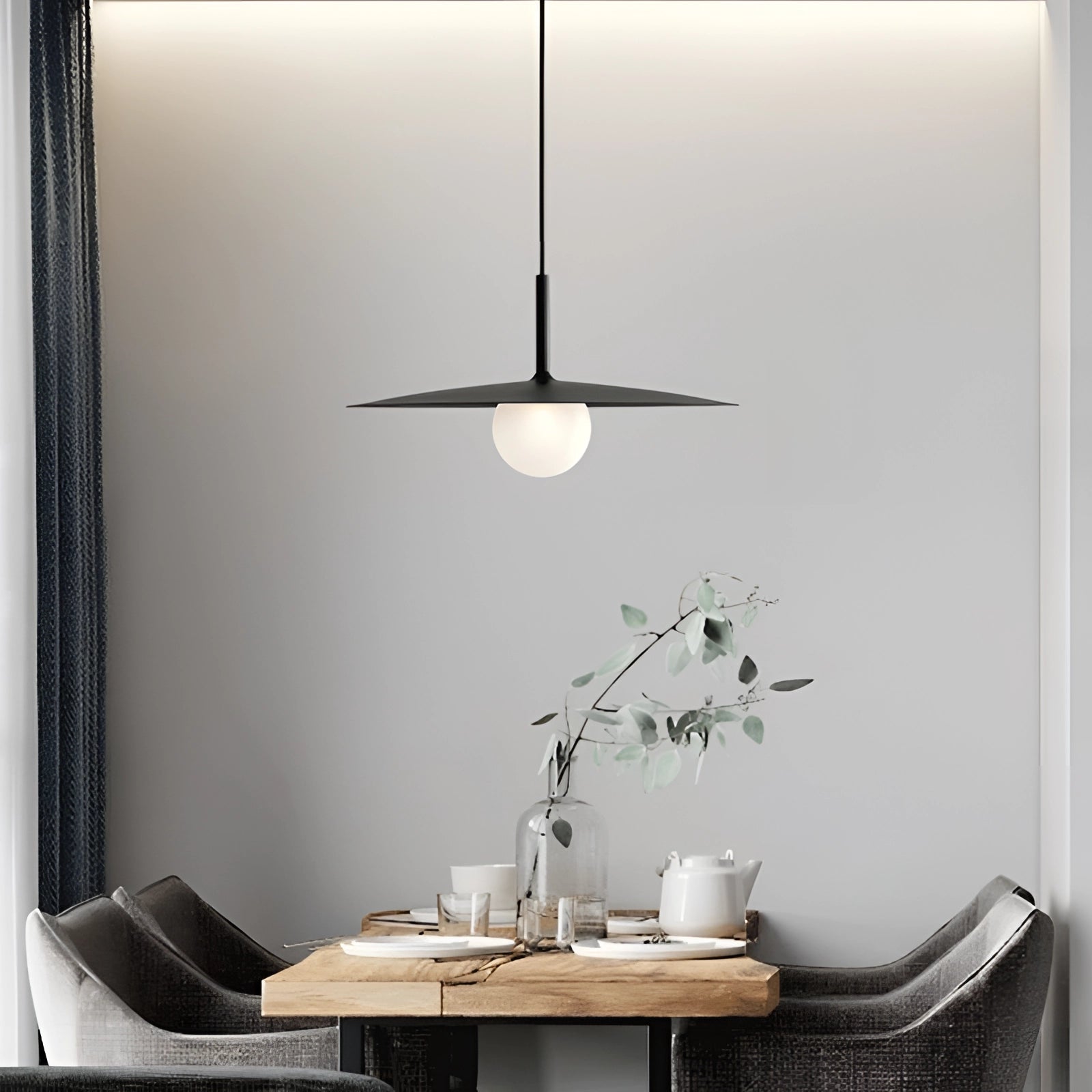 Modern minimalist LED pendant light with a Scandinavian dual-tone design, featuring a sleek rectangular shape. The pendant light is suspended over a stylish wooden table with a small potted plant, highlighting the white and wood elements of the furniture in a contemporary interior setting.