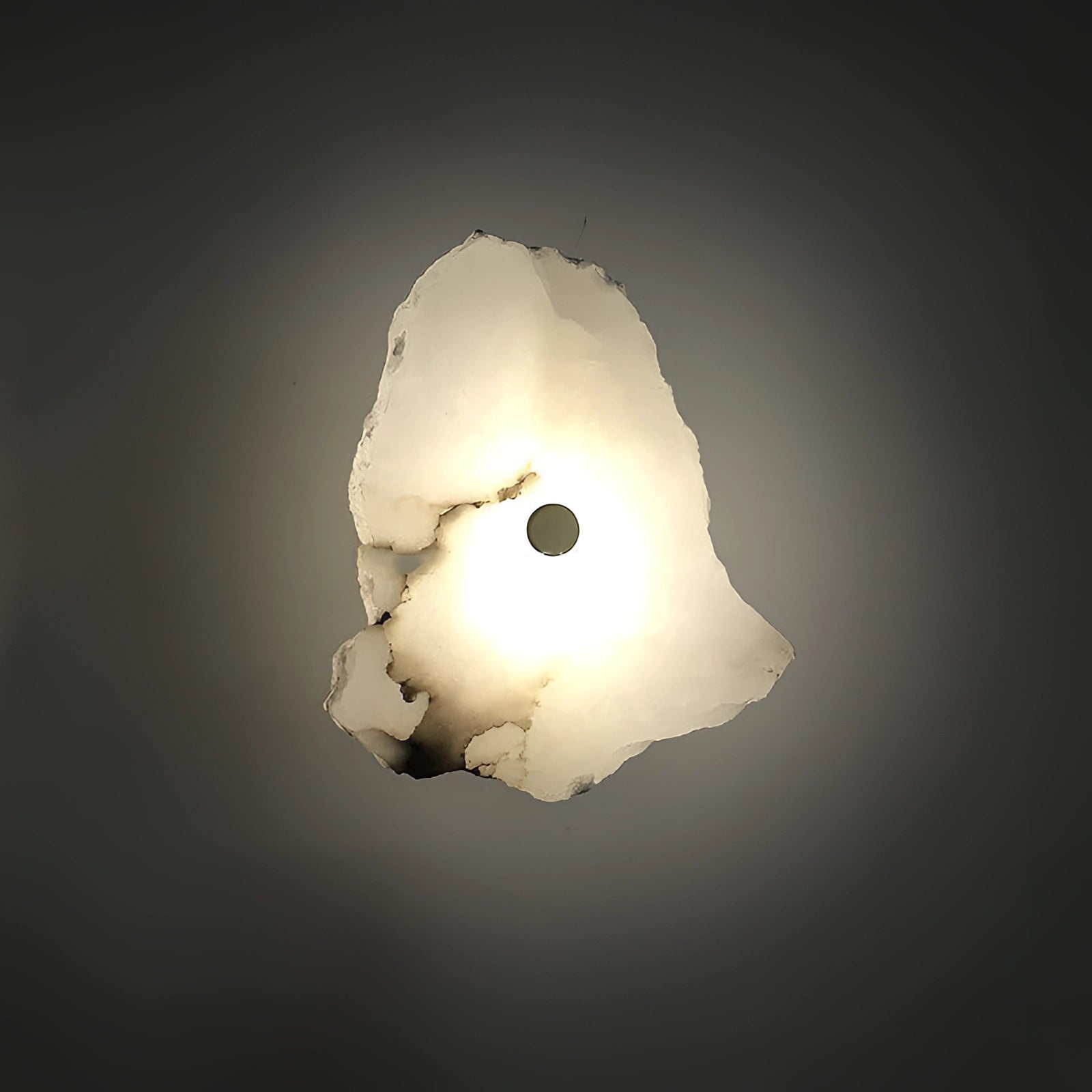 Modern Minimalist LED Wall Lamp in darkness featuring a sleek circular design with ambient lighting illuminating the wall, creating an artistic and atmospheric effect.