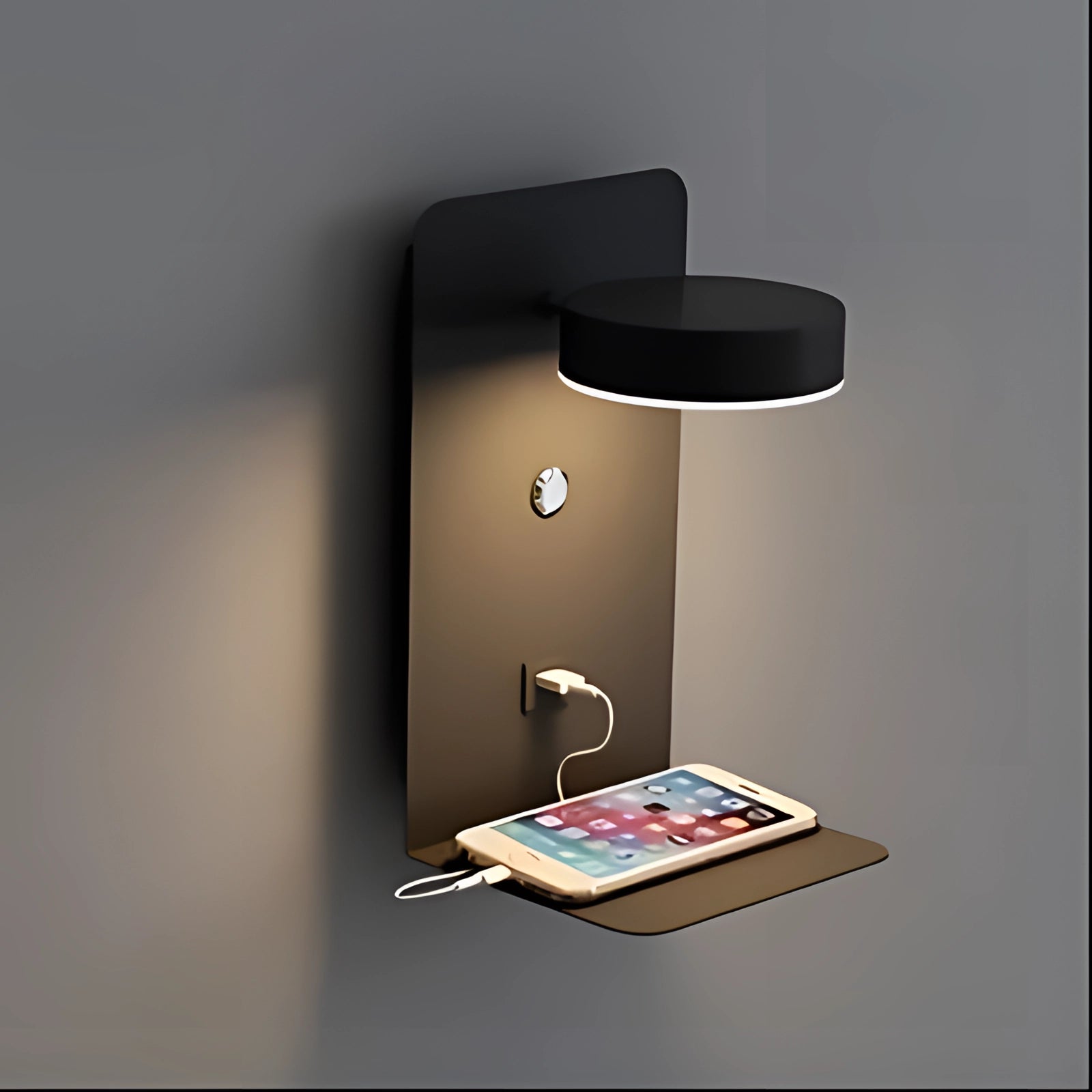 Modern minimalist black LED wall lamp with a rectangular design featuring a USB charger and a small shelf, holding books and gadgets, mounted on a wall.