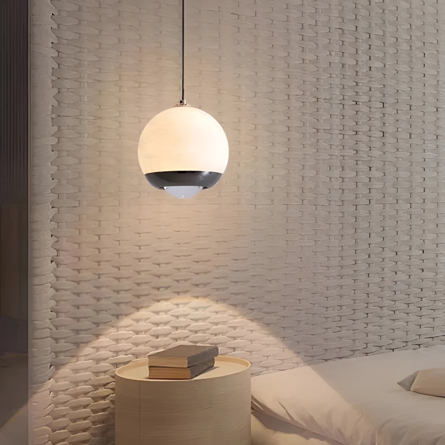 Modern minimalist white spherical pendant light hanging in a stylish bedroom with wood flooring and beige rectangular accents.